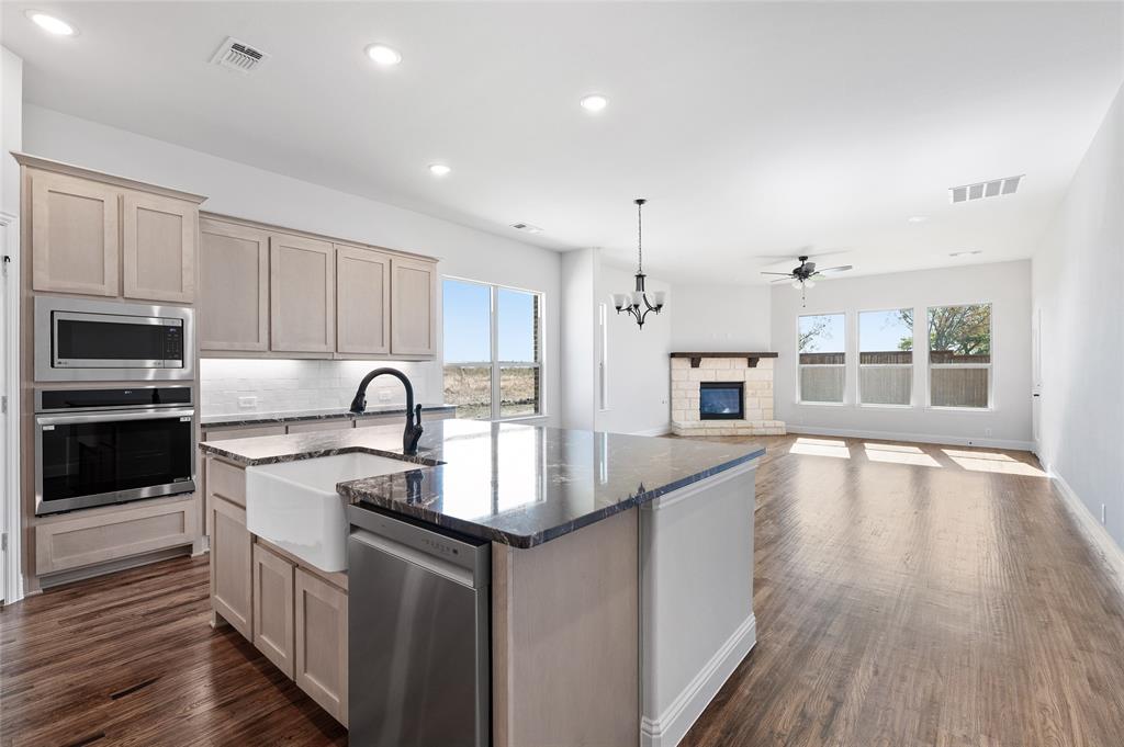 This stunning multigenerational home offers two full primary suites, each designed for comfort and privacy. The open-concept floor plan centers around a warm, inviting fireplace that seamlessly connects the living, dining, and kitchen areas—perfect for family gatherings. With a total of four spacious bedrooms, three full bathrooms, and one half bath, there’s room for everyone. A dedicated office provides a quiet space for work or study, while the large game room adds extra space for entertainment. The attached two-car garage offers convenience and additional storage. Designed for flexibility and modern living, this home blends comfort, style, and functionality for all generations.
