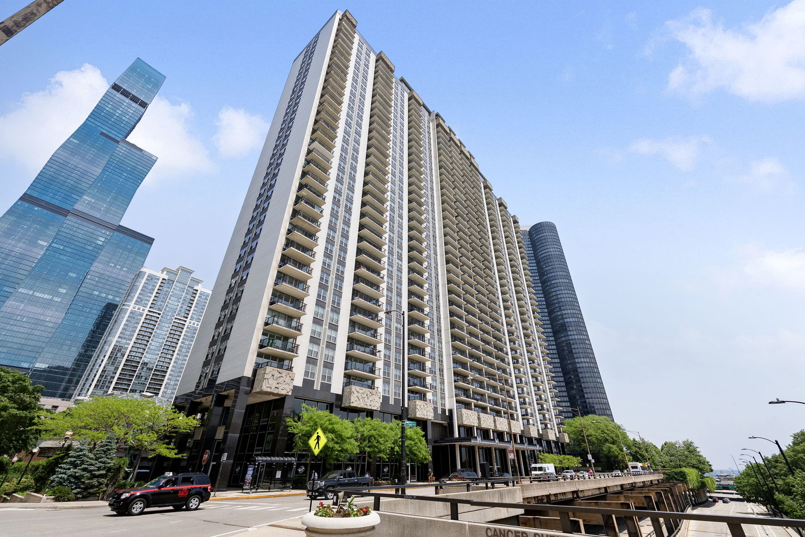 Get ready to fall in love with this fully renovated 2 bed, 2 bath condo that brings the wow factor. You'll have forever views of the lake, Monroe Harbor, Grant & Millennium Parks, the skyline, and even the museums-right from your windows or your huge 20' balcony (perfect for grilling, lounging, or just soaking it all in). Inside, everything's been redone with style. The custom kitchen features new cabinets, stainless steel appliances, quartz countertops with waterfall edges, and a breakfast bar. You've got sleek wood-look laminate floors, spa-like porcelain tile bathrooms, big walk-in closets, and tons of storage space. The building's recently updated too-with new windows and strong finances. And the amenities? Basically a luxury resort: sundeck, gym, spa, library, basketball court, weight and cardio rooms, kids' playroom, massage therapy, and a gorgeous domed indoor pool that's open all year. HOA covers heat, A/C, gas, cable, 24/7 security, and a doorman. Steps to the lake, trails, and parks. It's city living at its best-with a touch of luxury.