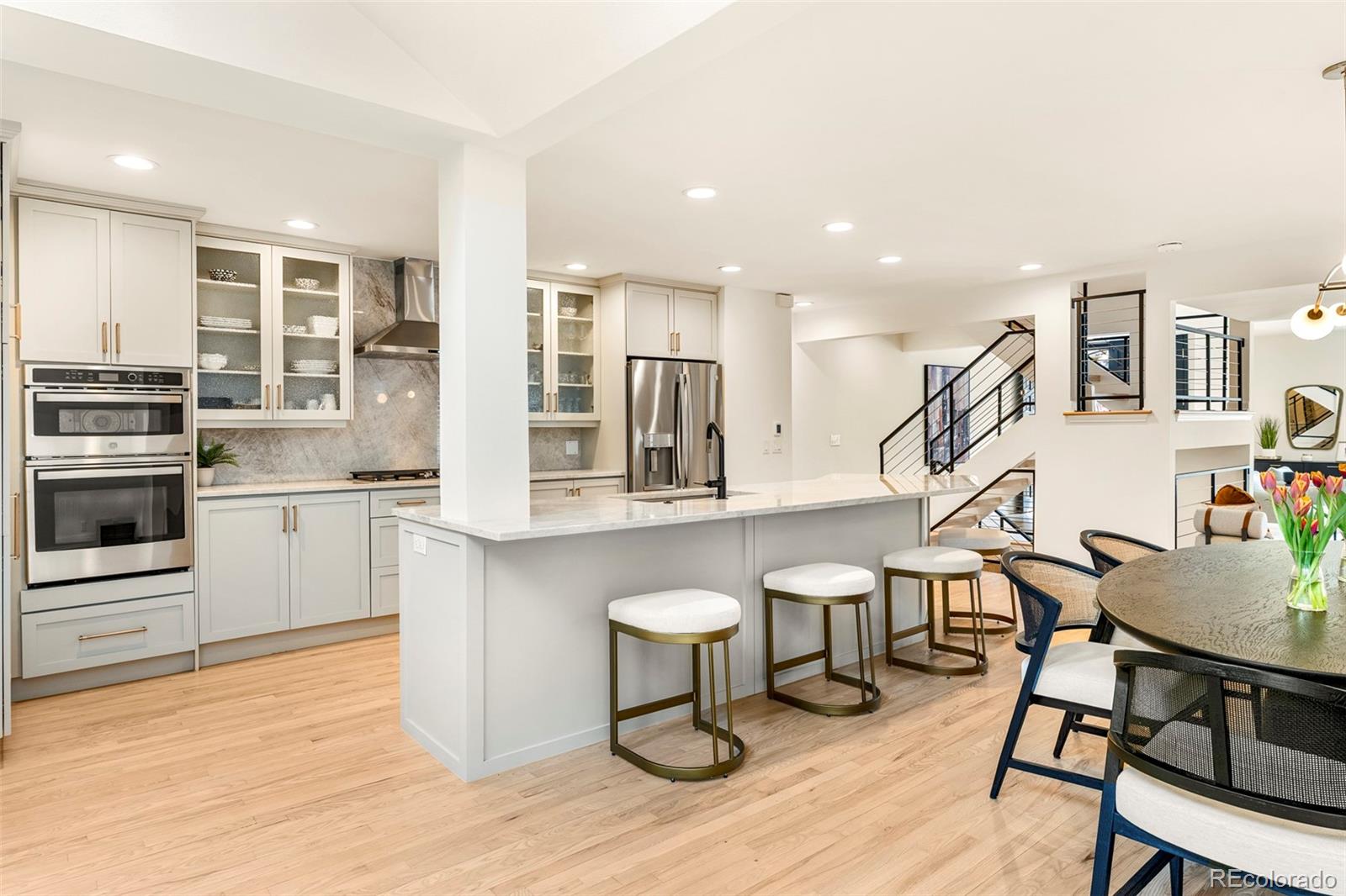 Welcome to this remodeled 2-bedroom, 3-bathroom townhome in the heart of Cherry Creek North, offering a rare alternative to condo living with contemporary design and abundant natural light. This south-end unit is light and bright, with inviting indoor and outdoor spaces.The main level features open-concept living with formal living and dining areas anchored by a sleek fireplace, plus vaulted ceilings and skylights for an airy feel. The updated kitchen includes Taj Mahal quartz countertops, glass cabinetry, a center island, and newer 2024 appliances.Upstairs, spacious bedrooms include a primary suite with a walk-in shower and dual vanity, connected by a modern floating staircase. Private patio spaces offer quiet retreats.An unfinished basement provides room to expand, while an attached 2-car garage plus 3 additional parking spaces offers 5 total parking spaces.Moments from Cherry Creek North’s top dining, shopping, and galleries.