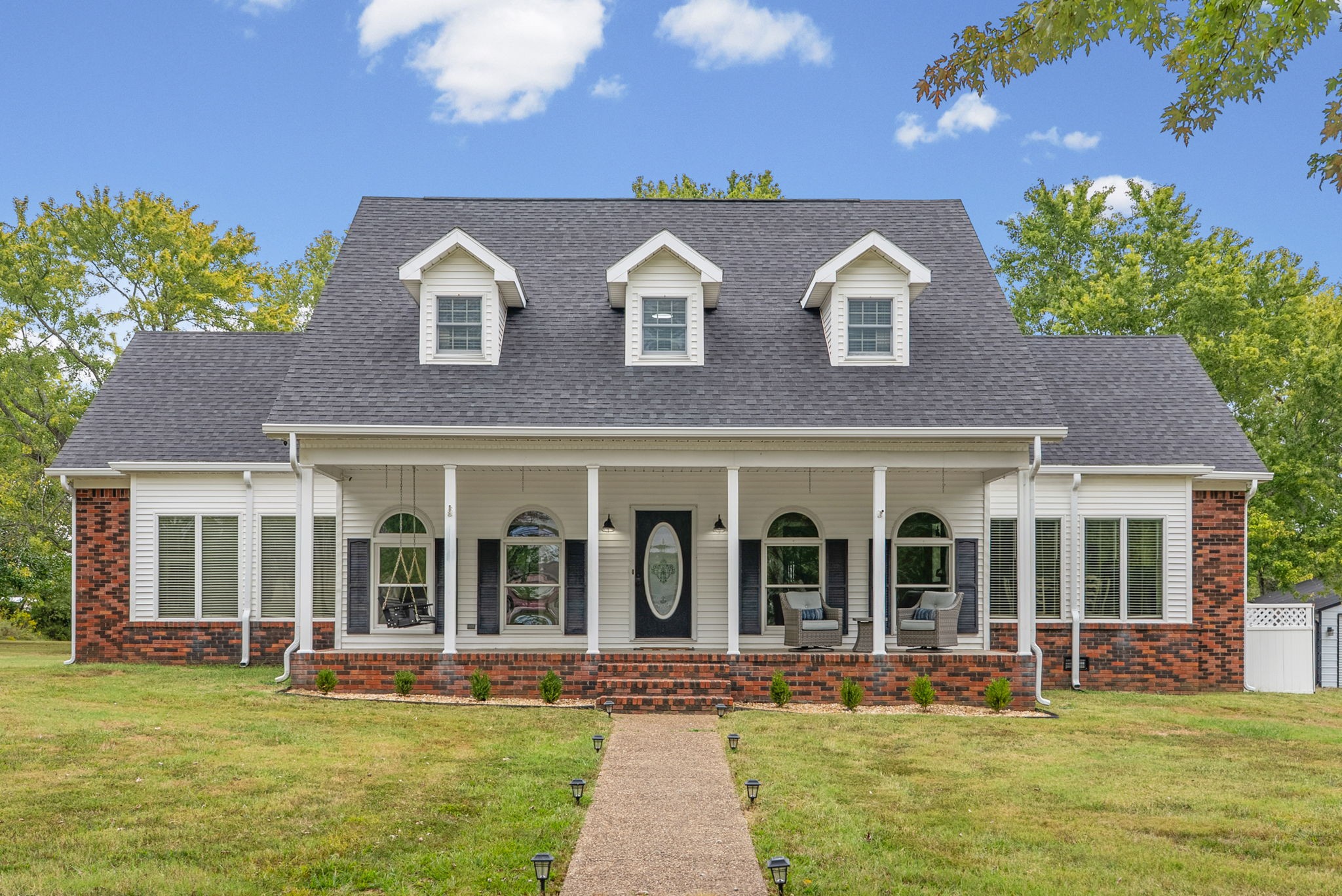Welcome home to this spacious 5-bedroom, 3.5-bath home situated on 5.5 acres with room to spread out inside and out! Freshly painted with new LVP and carpet throughout, this home offers a formal dining room, breakfast area, and a beautiful kitchen featuring custom cabinetry, granite countertops, pantry, and an oversized window above the sink overlooking the property. Abundant windows fill the home with natural light. The primary bathroom has been beautifully remodeled, along with an additional remodeled bathroom upstairs. Enjoy a large den addition, spacious laundry room with sink, custom closet shelving, an upstairs ensuite, walk-in attic storage, and a new upstairs HVAC unit. Outside, relax on the covered front porch with porch swing or enjoy the new patio. The property also features a storm shelter, detached shop, 3-stall horse barn, and chicken coop—offering the perfect blend of comfortable living and country lifestyle!
