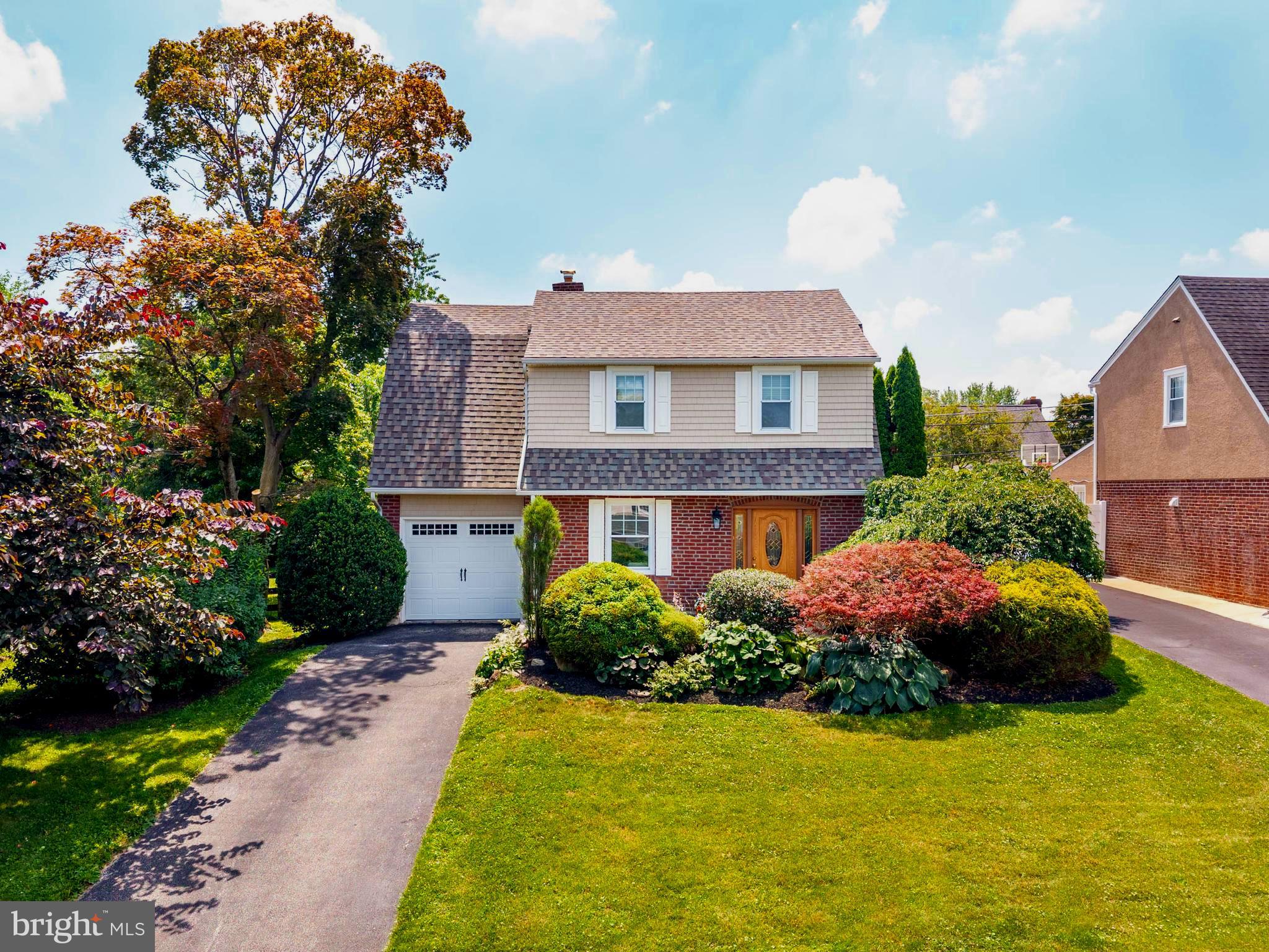 Welcome to this charming brick colonial situated in one of Wayne's most desirable neighborhoods. Grange Road is a quiet circular street maximizing tranquility.  This well-maintained 3-bedroom, 1-bath home offers timeless character with warm hardwood floors throughout the home, a bright living room, and a spacious dining room perfect for entertaining. The updated kitchen features stainless steel appliances and opens to a sun-filled bonus room with direct access to the beautiful patio and private, level, fenced backyard—ideal for quiet morning coffee, outdoor gatherings, gardening, or play. Additional highlights include an attached one-car garage, full basement offering abundant storage or future finishing potential, central air, natural gas heat, and numerous thoughtful updates completed over the years. Conveniently located near shopping, restaurants, parks, the Radnor Trail, and SEPTA train stations, with easy access to major commuter routes. Situated within the highly regarded Radnor Township School District, this home offers the perfect blend of classic charm, comfort, and an exceptional location!