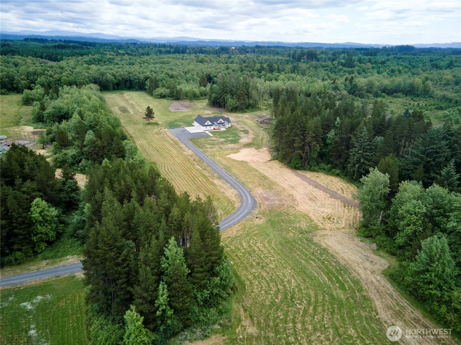 Located at the end of a quiet country road on 25 private acres this nearly brand new home dazzles with its clean design & finishes! Beautiful cedar paneled covered porch & inviting entry usher you into the open living rm w/vaulted ceilings & fireplace. Kitchen is a show-stopper w/Hickory cabs, white quartz cntrs & a built-in kitchen nook/bench (kitchen table stays!)&coffee bar +huge WI pantry. Primary Bed features a fireplace, fab bath w/tiled shower, dbl sinks & giant WI closet w/glass cabs. Laundry rm has a tiled dog shower! Oversized finished(insulated & heated too!)garage w/sep.rm for hobbies. Electric car charger. 24'wide Cedar T&G covered patio+extra patio space. Prepped for shop w/200 amps, water line& internet ran to site. MUST SEE!