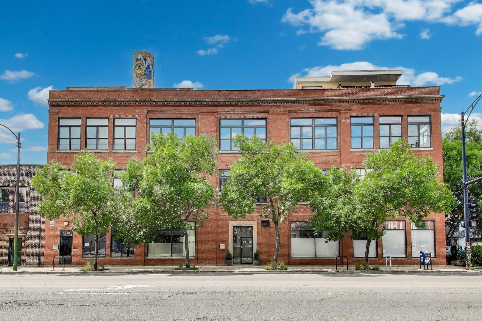 Welcome to 2401 W Ohio #31 - a show-stopping, top-floor 4 bed / 2 bath penthouse duplex in an exclusive boutique elevator building in Ukrainian Village/Smith Park. This expansive, light-filled corner unit spans over 3,000 sq ft and showcases true loft character with soaring 16'+ timber ceilings, exposed brick, oversized factory-style windows, and 50'+ of interior width.    The main level offers a dramatic open-concept layout featuring a chef's kitchen with Thermador and Bosch appliances, granite countertops, a large island with breakfast bar, and custom cabinetry. The kitchen flows into a massive living room and formal dining area-ideal for entertaining. A spacious main-floor bedroom, full bath, and ample storage complete the first level.    Upstairs, you'll find the true primary suite, complete with a spa bath featuring an oversized walk-in shower, and double vanity. The top floor also includes an additional bedroom, a stylish sitting area, a full laundry room, and access to multiple private outdoor terraces, including a wraparound rooftop deck with panoramic skyline views.    Additional features include triple-zoned HVAC, two private exterior storage rooms, in-unit laundry, and exterior parking included.    Unbeatable location near Smith Park, public transit, top restaurants, and quick access to 90/94 and all that West Town has to offer.