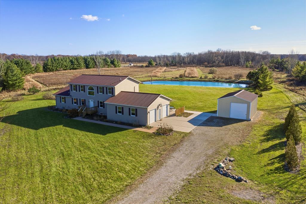 Stunning split colonial set on 10 peaceful acres with a main-floor primary suite and geothermal heating for exceptional energy efficiency. This spacious home offers four bedrooms plus an additional loft that can easily serve as a fifth bedroom, office, or flex space. The open layout includes two full baths and one half bath, along with an extra-deep basement ideal for storage or future finishing. Enjoy breathtaking views of the large, deep pond and the abundant wildlife that surrounds the property. A generous pole barn provides excellent space for equipment, hobbies, or additional storage. This rare country setting delivers privacy, nature, and room to grow while still offering modern comfort and convenience. A perfect retreat for those seeking acreage, outdoor living, and a versatile home designed to fit a variety of needs. This home checks every box you are looking for and seller is offering immediate occupancy. Get settled in just in time for the holidays!