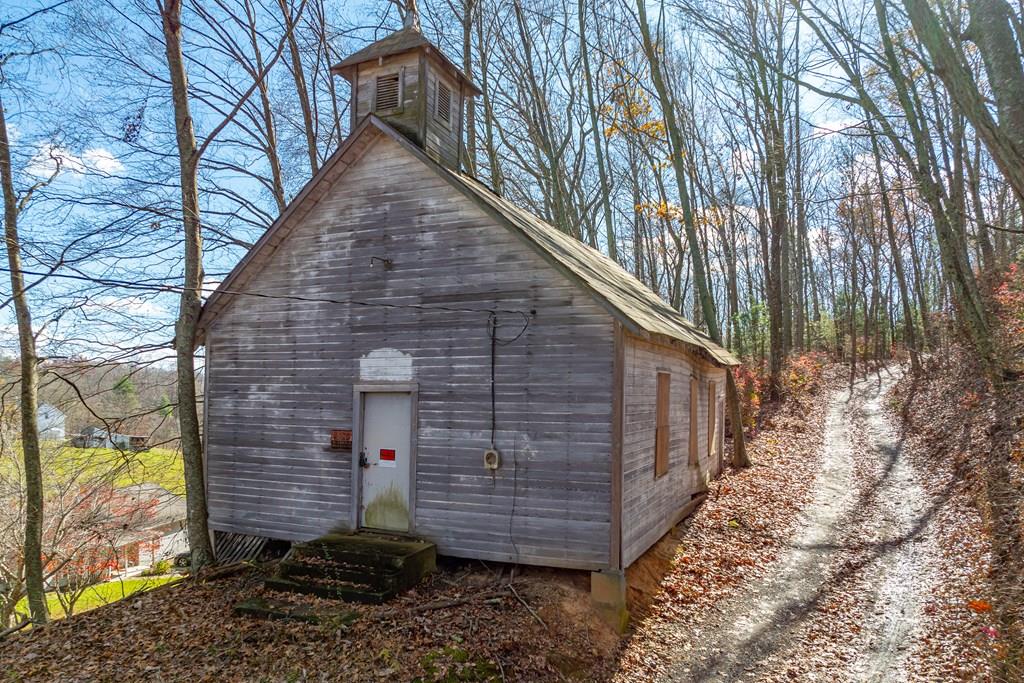 Sitting in the Blue Ridge Mountains of Virginia, the historic Webb Presbyterian church built c.1900 offers a unique opportunity to own a piece of local Appalachia history. Situated on a .3 acre, the property exudes tranquility as it's hidden in the peaceful yet conveniently located countryside, only half a mile to HWY 58. This church is in need of modernization but does have electricity, making it a perfect project for preservation enthusiasts, artists, or visionaries seeking a one-of-a-kind retreat. Featuring authentic original architecture, including locust wood-frame structure, amber stained glass windows, and pitched roof clad with pressed tin shingles, the building has charm and lots of potential. Located in close proximity to the areas of Hillsville, Meadows of Dan, and Fancy Gap. Activities, sights, and events such as Galax's annual Old Fiddlers Convention are plentiful in this mountain community. Call today for the opportunity to own a property from a simpler time!