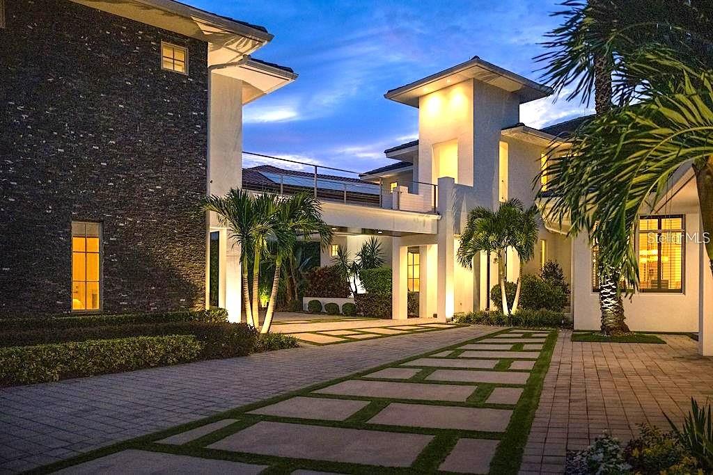 Welcome to 9721 Carillon Park Dr, Windermere, FL 34786,  a stunning estate inside the guard-gated community of Keene’s Pointe.This extraordinary residence offers 8,305 square feet of luxury living space with refined architectural details, elegant wood beams, and designer finishes throughout.MAIN FEATURES:        •       Five bedrooms plus DETACHED GUEST HOUSE and OFFICE— providing exceptional space and privacy.        •       Expansive master suite with private sitting room, balcony overlooking the pond, dual closets, fireplace, and breakfast area.        •       Chef’s kitchen with a large island, seating area, top-of-the-line appliances, and a hidden walk-in pantry.        •       Bar and game room featuring real wood finishes and picturesque pond views.        •       Private GYM with SAUNA for health and relaxation.        •       Nine-seat HOME THEATER with plush carpet flooring for an immersive movie experience.        •       Four-car split garage (2/2), ELEVATOR, and downstairs laundry room.        *       Additional laundry closet inside the upstairs primary bedroom closet. OUTDOOR & LIFESTYLE:Seamlessly blending indoor and outdoor living, the open floor plan connects to a heated pool and spa area, surrounded by tranquil pond views and lush landscaping. The fully retractable sliding doors make it ideal for entertaining year-round.RECENT UPGRADES INCLUDE:        •       Five new AC units (2023)        •       Hurricane-impact windows and ADT smart security system        •       New pool equipment (2022)        •       Exterior repaint (2023)        •       Full surround-sound system throughout the homeCOMMUNITY & LOCATION:Located within the prestigious Keene’s Pointe community, residents can enjoy The Golden Bear Club, featuring a Jack Nicklaus Signature golf course, clubhouse, fitness center, and dining.Windermere is renowned for its lakes, top-rated schools, and luxury lifestyle just minutes from downtown Orlando and Disney attractions.This home represents the pinnacle of luxury living in Windermere, offering elegance, privacy, and resort-style amenities.Schedule your private tour today and experience the sophistication of this remarkable estate.