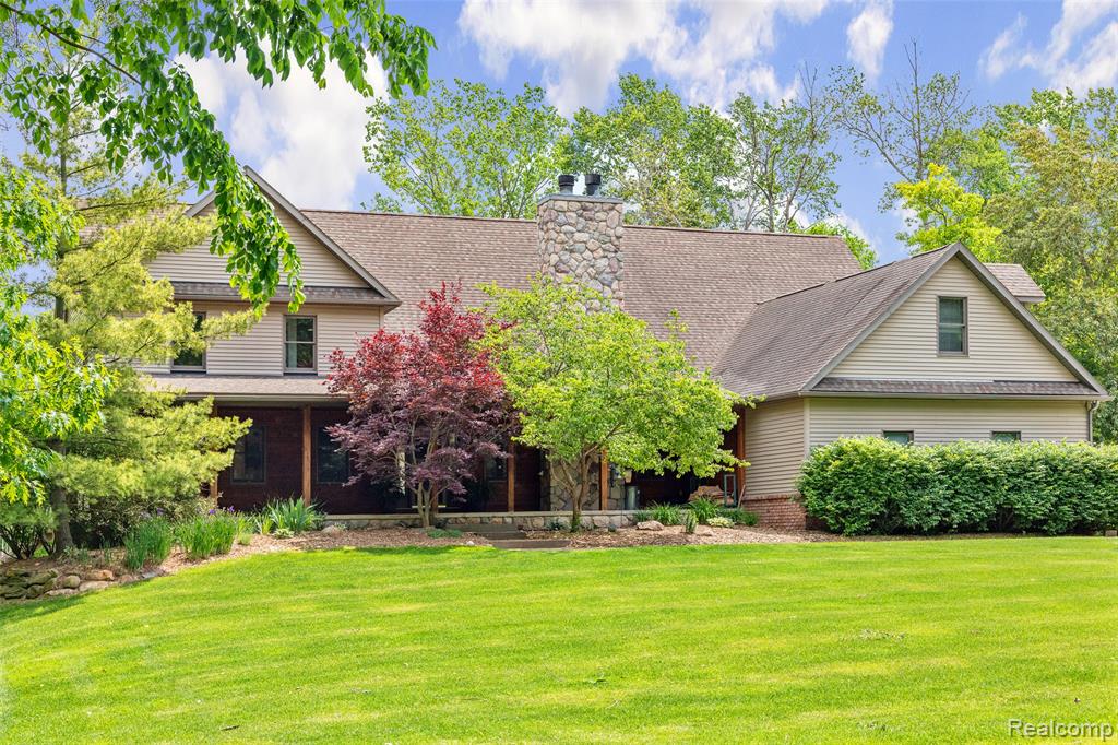 Welcome to your own private retreat in Lake Orion! Tucked away at the end of a quiet private road and nestled on 5.77 wooded acres across from a bird sanctuary and near Orion Oaks Park, this multi-generational estate offers the best of both worlds—peaceful seclusion with convenient access to area amenities.
Boasting 4,384 sq ft of living space, this thoughtfully designed property features two distinct homes connected by a shared laundry room and a spacious 3.5-car garage—ideal for multi-family living or hosting guests with ease.
The primary home has a relaxed, comfortable feel with a large great room, two natural fireplaces, and a stunning kitchen with granite countertops and stainless steel appliances. The second residence (In-Law Quarters) offers a more refined touch, featuring a stylish island kitchen with dining space, a large living room, luxurious master suite with private bath, and a finished lower level complete with wet bar, family room, bedroom, and full bath.
Outdoor living is just as impressive—French doors lead to an expansive patio perfect for entertaining, while the upper-level deck with glass railing invites you to take in the surrounding nature. A covered 12x50 cedar front porch offers a peaceful spot to relax and enjoy the sights and sounds of wildlife.
For the hobbyist, car enthusiast, or those needing extra storage, the 40x60 pole barn with concrete floors, water, electric, and a 24x16 overhang is a dream come true.
This is more than a home—it’s a lifestyle. Experience the beauty, privacy, and versatility this incredible Lake Orion property has to offer.     
Please note:  a few rooms are virtually staged.