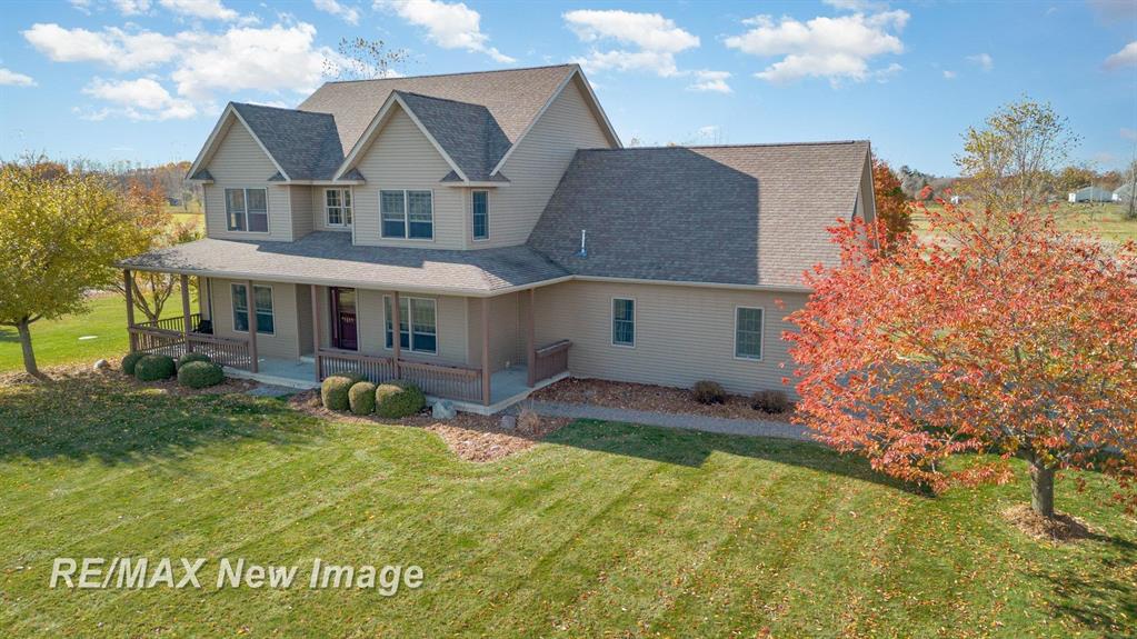 5 Bedrooms \ 4.5 Baths \ 4,535 Total Finished Square Feet \ 14.46 Acres \ Pole Barn \ Pond  Experience the Ultimate Country Escape in Freeland Discover a stunning blend of luxury and tranquility on over 14 acres in Freeland. This beautifully crafted five-bedroom, 4.5-bath retreat offers plenty of thoughtfully designed living space for your family including an amazing fully finished basement and bar area built for unforgettable entertaining. Step into a vaulted foyer and relax in the inviting living room, complete with a cozy gas fireplace. The main floor master suite is a true sanctuary, featuring dual walk-in closets and a spa-inspired bathroom. Work or unwind in your private main floor den or home office and enjoy the convenience of main floor laundry, a handy laundry chute from the second floor and plenty of extra pantry storage. The spacious open concept kitchen and dining room features KraftMaid luxurious maple cabinets, custom granite countertops, and premium stainless appliances. Upstairs, you'll discover four spacious bedrooms with impressive, vaulted ceilings, two full bathrooms, and a versatile bonus room above the garage-ideal for a playroom, home office, or guest suite, offering endless possibilities for your lifestyle. The finished basement is an entertainer's dream, featuring a workout room and a custom bar with sink, fridge/freezer, and kegerator-perfect for hosting friends and family. Step outside to your own private paradise: a serene pond, multiple apple trees, and daily visits from local wildlife. The impressive 40x64 pole barn is complete with 100amp electrical service, 16-foot ceilings, a 14-foot garage door, sliding barn door, concrete floor with drains and water at the barn.  The property also features an automatic underground tree watering system, covered front porch, a composite back deck and a hot tub on a stamped concrete patio to complete the outdoor experience. Enjoy peace of mind living in this well-equipped home with it's Generac whole-house standby generator, 400-amp electrical ser