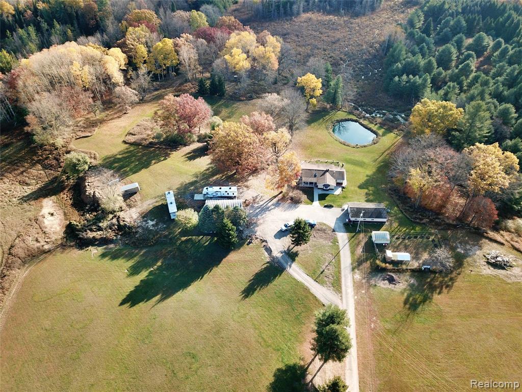 Spacious 3-bedroom, 2-bath home offering 1816 sq ft of comfortable living space  on main floor and another 1540 sq ft livable walkout basement, a total of 3356 sq ft, all nestled on 18 peaceful acres. Enjoy a private pond, perfect for relaxing or watching wildlife. This property features a 24x48 garage and a 32x46 pole barn—ideal for vehicles, equipment, or hobbies—plus a greenhouse for gardening enthusiasts. The home boasts generous storage throughout and room to grow both inside and out. Conveniently located just 15 minutes from Tawas and 40 minutes from Kalitta Air Transport, this property offers the best of country living with easy access to town. Whether you are looking for a hobby farm or a place to raise horses, this is the place! A true up north retreat with endless possibilities!