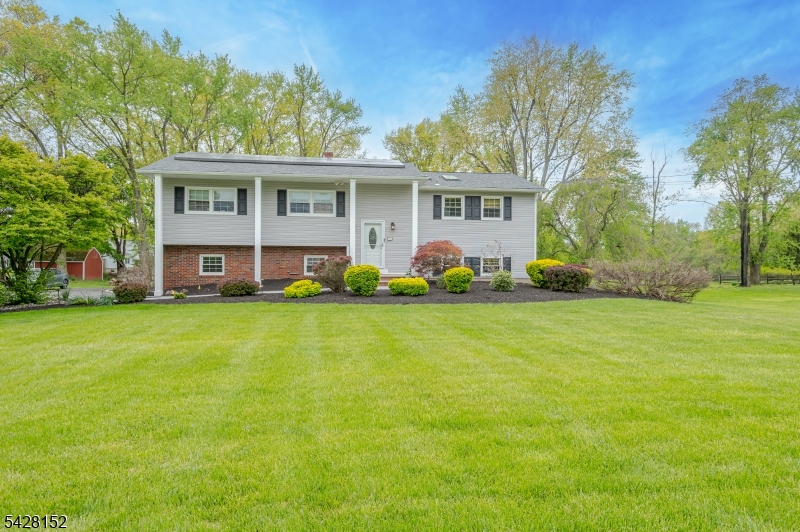 Just unpack! Nestled on a park-like 1-acre lot, this bright and airy 4-bedroom, 2.5-bath, 2 car garage, bi-level home is waiting for you. Highlights include hardwood floors, a wonderful stone fireplace in the family room, and doors that lead to a brand-new patio complete with a fire pit. Additional upgrades include a new driveway and updated bathrooms, featuring radiant heated tiles in the main bath. Leased solar panels. The home features multiple windows that provide a sun-kissed aura throughout. Ideally located near shopping, golf courses, Route 206, and Montgomery Schools, this property offers the perfect combination of price, location, and layout.
