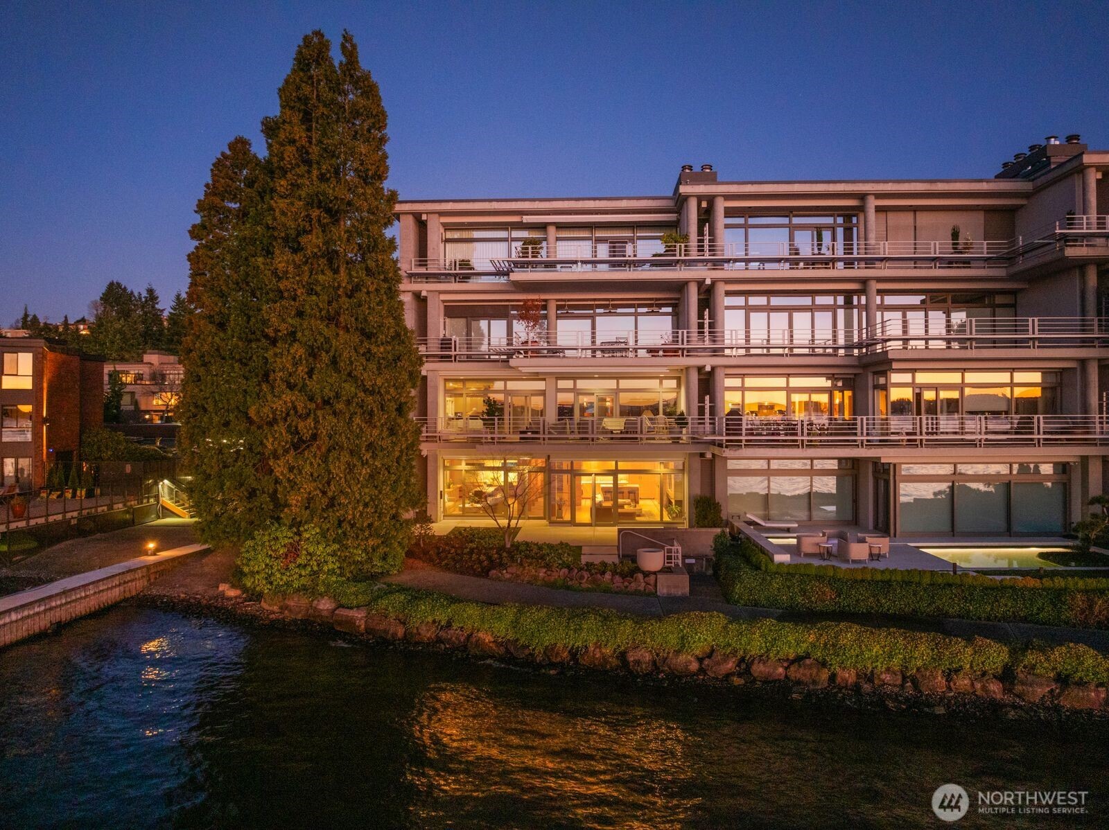 Remodeled by renowned architect Jim Olson of Olson Kundig, this exceptional Lake Washington condominium showcases his signature attention to fine millwork, paneling, and timeless design. Situated at the water’s edge, this rare single-level residence offers unobstructed views of Lake Washington, the Olympic Mountains, and the surrounding city skylines. The thoughtfully renovated kitchen, living, and dining spaces flow effortlessly together, creating an airy, light-filled environment with a seamless connection to the water beyond. A generous primary suite features an expansive walk-in closet and front gated yard, complemented by a second bedroom and bath. Additional highlights include a dedicated utility room and a separate mechanical room. Enjoy remarkable privacy while remaining just minutes from premier amenities. A comprehensive exterior refresh was just completed, enhancing both curb appeal and long-term value. An exceptional home whose quality and presence are best appreciated firsthand.