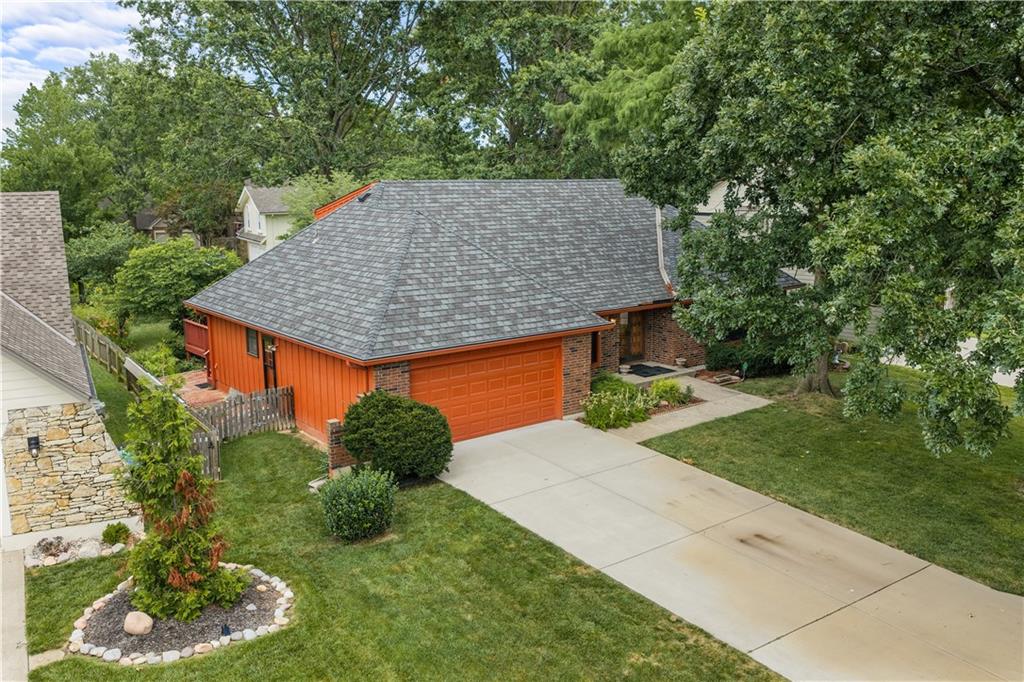 This beautiful brick-front home welcomes you with timeless curb appeal and classic charm. Step through the elegant custom double entry doors and immediately notice the care and love that have been poured into this home. The grand entry features beautiful designer tile flooring that leads into a stunning living room with soaring cathedral ceilings. Complete with exposed ceiling beams, a custom wood accent wall, built-in shelving, an open-concept layout, and a cozy central fireplace, this is the perfect space for making lasting memories. The home offers two dining areas to fit your lifestyle. Enjoy casual meals in the eat-in kitchen, complete with an extended breakfast bar that's perfect for additional seating, or entertain guests in the formal dining room, which could also serve as a sitting room, home office, or library. A private upstairs bedroom with its own full bath provides an ideal retreat for guests or family members, while two additional full bathrooms on the main level add convenience for everyday living. The finished basement offers endless possibilities, with flexible space for a recreation room, home office, additional bedroom, workout area, or any combination that suits your needs. Outside, you'll find a scenic backyard with a generously sized deck overlooking a beautifully treed, shaded lot—an ideal setting for relaxing or entertaining. Best of all, this home is just steps from the lake, making it easy to enjoy the outdoors whenever you like. This is a home you'll want to see in person! Lakewood Property Owners Association (LPOA) residents have access to a range of amenities including three swimming pools, a golf course (extra), marinas, tennis courts, pickle ball Courts, B-Ball courts, volleyball courts, gym, and more. With 365 acres of no-wake lakes and a strong sense of community, this home offers a well-balanced lake lifestyle.