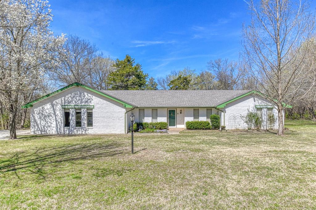 If you're dreaming of having an acreage five minutes from dining and shopping with a waterfront view and tons of potential, it's 1609 E Post Oak Road for the win! Settled on a gated double lot with trees galore, you'll find a sweet 4-bedroom home, 3 barns, and a large pond with a dock for fishing! This charming and unique home offers 2 primary suites, each with full bathrooms and tiled walk-in showers. In addition to that are 2 guest rooms, a separate third full bathroom with tub/shower combo, and formal dining area. The living room comes with a cozy wood-burning fireplace and wet bar, making that evening cocktail a little more convenient to fetch during your favorite show. Step out into the nice-sized sunroom, tiled and climate controlled with a ceiling fan and window AC unit for enjoyment during any season! Then continue onto the open deck out back to experience the outdoor quietness and serenity.  The kitchen offers electric appliances, a breakfast bar for casual dining, along with a breakfast nook that boasts a giant bay window for added natural light! The property also provides 3 barns or outbuildings that are hooked to electricity, with the main barn offering 3 stalls and a tack room, plus water service. For peace of mind, the home does come with updated HVAC and water heater, an electric entry gate, as well as a storm shelter on the property.  A few short miles from the University of Oklahoma's south campus this property is on two seperate parcels.   City  of Norman water!
