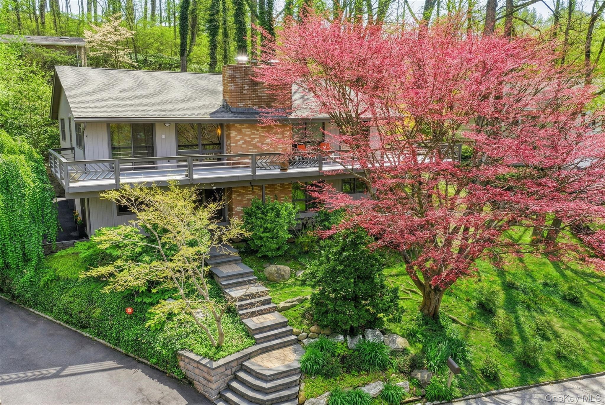 Set within the Incorporated Village of Sea Cliff with views of Hempstead Harbor and moments from Tappen Beach, the marina, and the Sunset Grill, this striking Mid-Century Modern residence offers approximately 3,200 square feet of living space across two levels. Four bedrooms include a private primary suite, three full bathrooms, and a finished lower level perfect for extended living — all within a layout that lives comfortably and entertains effortlessly.The home has been well maintained and thoughtfully updated, featuring natural gas heating and cooking, central air conditioning, modern appliances, and generator readiness throughout. Low-maintenance grounds with beautiful specimen plantings complete a property that is as move-in ready as it is architecturally distinctive.