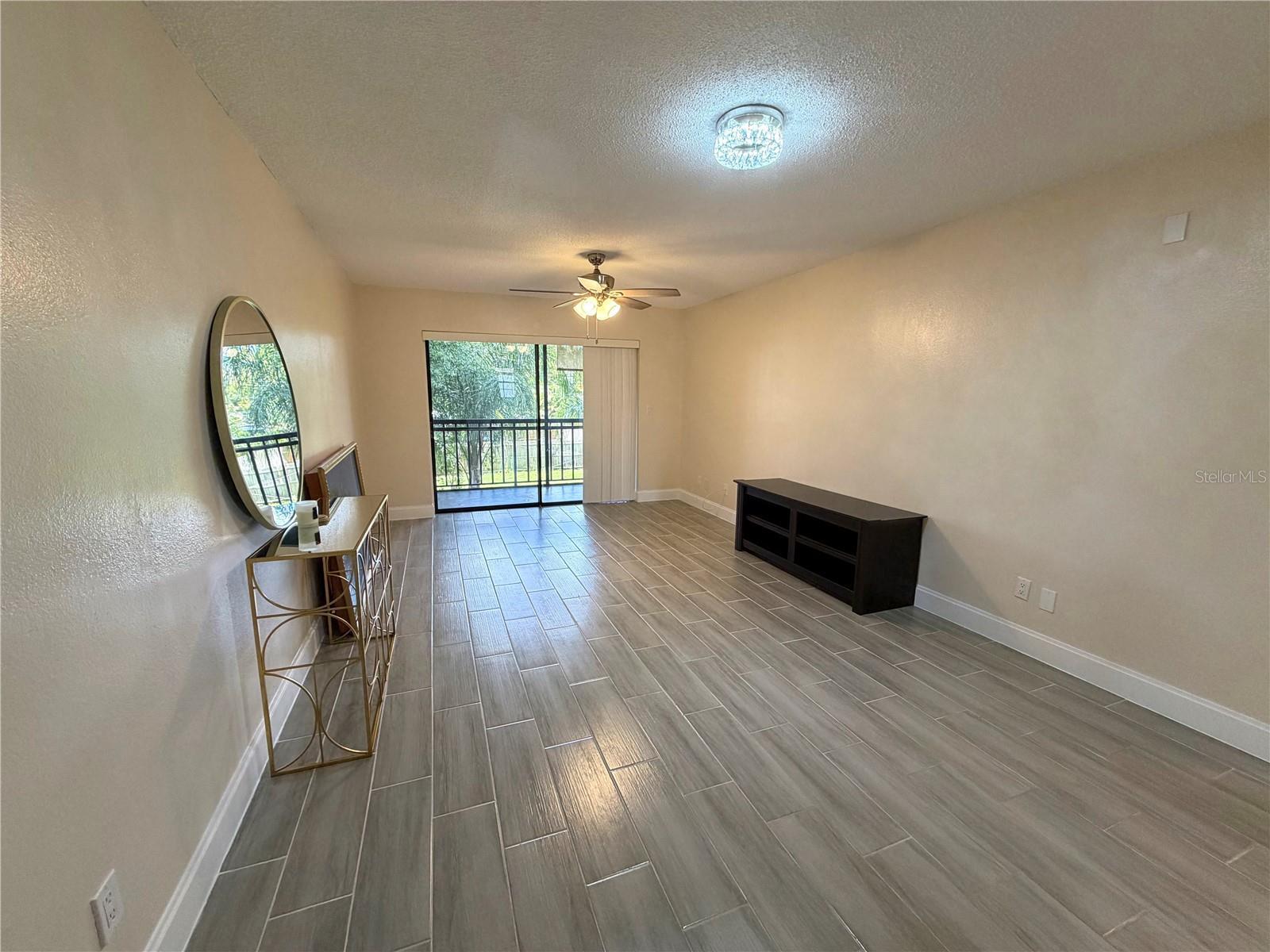 Beautifully updated and move-in ready, this 2-bedroom, 1-bath second-floor condo offers modern finishes, thoughtful updates, and low-maintenance living in a convenient Pinellas Park location. Professionally renovated in 2023, the home features wood-look tile flooring throughout the main living areas, neutral finishes, and an abundance of natural light. Sliding glass doors lead to a private balcony overlooking the surrounding greenery, creating a comfortable extension of the living space. The updated kitchen includes new appliances, while the in-unit laundry adds everyday convenience.The community has no age restrictions, offering flexibility for a variety of buyers. The $430 monthly HOA includes water, sewer, trash, roof maintenance, building insurance and groundskeeping. Ideally located near shopping, dining, parks, major roadways, and the Gulf beaches, this condo combines the convenience of a central location with the appeal of a fully updated home. A great opportunity for a first-time buyer, those looking for a convenient, move-in-ready home, or an investor seeking a low-maintenance property.