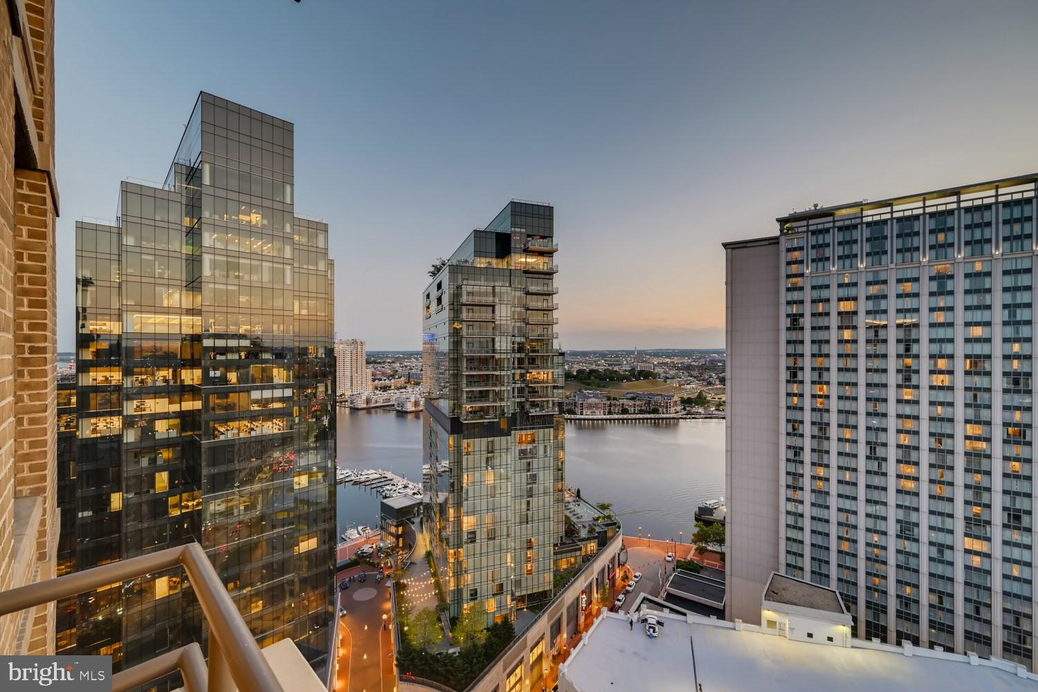 Perched high on the 27th floor of The Vue in Harbor East, this spectacular two-bedroom, one-and-a-half-bath residence delivers breathtaking panoramic views of the harbor, water, and Baltimore skyline. Floor-to-ceiling windows flood the open-concept living space with natural light, seamlessly connecting to a private balcony perfect for taking in the vistas. The chef’s kitchen is both stylish and functional, featuring a center island, sleek glass backsplash, and modern finishes ideal for everyday living and entertaining. The sun-filled primary suite offers expansive windows, dual closets, and a spa-inspired bath with double vanity and glass-enclosed shower. A versatile second bedroom with custom built-ins functions beautifully as a guest room, den, or home office. One covered garage parking space conveys.  The Vue condominium is located in Baltimore's hottest neighborhood within steps to the finest restaurants, boutique shops, Whole Foods, Starbucks, the Inner Harbor, waterfront and nightlife. **The condo Fee** includes heat, AC, hot water, water, sewer, front desk staff, package acceptance, building maintenance, onsite management. Take the elevator to the outdoor green space on the 8th floor for some fresh air or walking the dog without leaving the security of the building. Take the elevator to level 2 to the MAC gym and Harbor East Cinemas. Conveniently located to I-83.