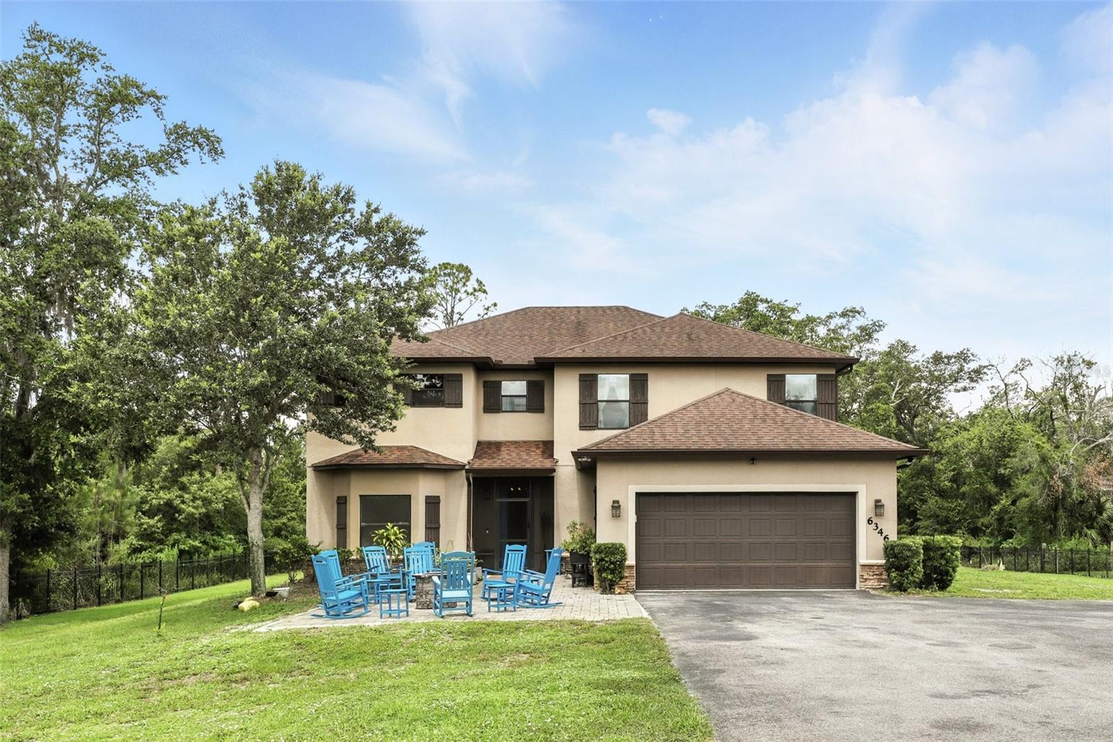 Don’t Miss Out on This Stunning Opportunity in Wedgefield Estates!
This is your chance to own a luxury retreat on a fully cleared, landscaped, and fenced acre of land. Perfectly blending space, privacy, and comfort, this property offers everything you’ve been looking for—without the restrictions of an HOA.
From the moment you arrive, you’ll appreciate the seclusion and peacefulness of this private sanctuary. The fully automated gates provide not only security but also the convenience of private access. With no neighbors on either side, your sense of privacy is truly unparalleled.
Relax and entertain in the inviting fire pit area, where you can enjoy beautiful views of the natural surroundings and clear, starry skies. Inside, the home welcomes you with a bright and open entryway, leading into a spacious and flexible layout. To one side, you’ll find a multipurpose room, versatile and ideal for a private office, playroom, or a quiet retreat.
The heart of the home is the open-concept living, dining, and kitchen space. With soaring 9' ceilings, custom woodwork throughout, and plenty of natural light, this area is designed for both comfort and style. The chef’s kitchen is a true highlight, featuring all-new stainless steel appliances, granite countertops, an island that seats six, and sleek custom cabinetry with beautiful tile backsplashes. For added convenience, built-in slide-out pantry shelves provide ample storage. Beyond that, the great room boasts elegant built-ins, crown molding, and chair rail details, offering the perfect setting for gatherings with friends and family. Large windows and sliding glass doors throughout the home allow tons of natural light into the space and present incredible views of the expansive yard. Meanwhile, a dining area at the back overlooks the backyard, making it ideal for hosting both dinner parties and casual meals. 
The spacious Primary Bedroom Suite is tucked away for privacy and features an en-suite bath with dual vanities, an abundance of cabinet storage, a garden tub, and a separate shower. 
Upstairs, you’ll find a generous bonus room that could serve as a movie room or additional living space, along with four large secondary bedrooms and two full bathrooms.
The outdoor living space is just as impressive, with a huge screened-in porch running the full width of the house and an open patio area with ample space for patio furniture and grilling. This is the perfect space to enjoy your morning coffee, soak up the Florida sun, entertain friends and family, or wind down after a long day, all while staying safe from mosquitoes.
Wedgefield Estates isn’t just about the home, it’s about the lifestyle. The 9,000-acre community includes a K-8 school, an 18-hole public golf course, and a large park with a dog park. For nature lovers, the Hal Scott Preserve is just steps away, offering hiking, biking, horseback riding, and fishing along the scenic Econlockhatchee River. With quick access to SR528, you’re only 15 minutes from the airport, Lake Nona’s vibrant dining and shopping scene, and 30 minutes to Florida’s beautiful Space Coast. Universal and Disney parks are just a 35-minute drive away, making this one of Orlando’s best-kept secrets.
Schedule your tour today—this one won’t last long!