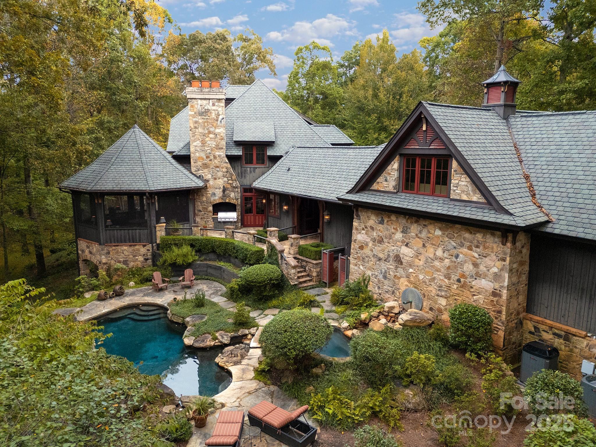 Private, poised, and perfectly suited inside the coveted Golden Hills & Greenspace communities, this exceptional 94.5-acre estate pairs refined architecture with sweeping privacy and open land. for the lifestyle you’ve been seeking. Set on nearly 95 acres within both the Golden Hills & Greenspace communities, this estate commands both setting and structure.The 8,424 sq ft main residence reflects timeless craftsmanship, with stone and wood detailing, generous natural light, elevator, and multiple levels of thoughtful, livable space. Designed with equestrian ambition and refined living in mind, the property includes an 7-stall barn, fenced pastures, and access to the community’s private riding trails.A 3,000 + sq ft guest house offers complete independence for family, guests, or staff. Along the Pacolet River, a long stretch of scenic frontage offers the perfect place for fishing, swimming, picnics, or quiet reflection by the water.Golden Hills & Greenspace are among the Foothills’ most sought-after communities, celebrated for its privacy, preserved open land, and proximity to Landrum, Tryon, shopping, hospitals and the region’s premier equestrian venues. This location offers an easy drive to Greenville, Asheville and Charlotte.