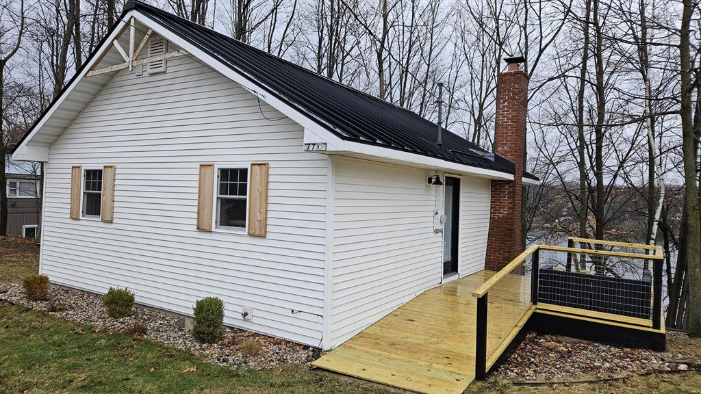 Completely remodeled cottage on Five Lakes. Two bedroom, one bath home with beautiful cathedral ceilings. All new siding, windows, doors and standing seam metal roof on the exterior. The interior was taken down to the studs. All new plumbing (drains and supply lines), electrical (including panel), furnace, and on demand water heater. The interior boasts tongue and groove pine walls and ceilings, tile shower, LVP flooring, quartz countertops and new appliances. The deck was just resurfaced. Nothing left to do but grab your suits and get ready for the warm weather.