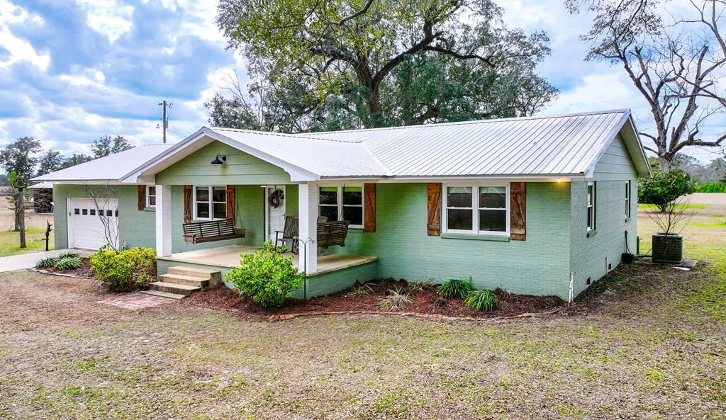 Ideally situated just 5 miles from Lake Seminole and Wingate's Landing, perfect for boating, fishing, and weekend adventures, and only 35 miles from Tallahassee for an easy commute or quick city getaway, this property offers the best of both worlds. From the moment you arrive, you're welcomed by over 100 acres of breathtaking oak trees, planted pine, pasture and sweeping views that instantly make you slow down and stay a while. Whether you envision planting, raising animals, or simply enjoying wide-open space, this property offers the perfect setting with incredible privacy.  Inside, the updated farmhouse features a bright, open layout designed for both comfort and entertaining. The kitchen is light and airy with stainless steel appliances and flows seamlessly into two separate living areas, providing flexible spaces for gatherings and everyday living.  The primary suite offers a peaceful retreat, complete with a spacious walk-in shower and a generous walk-in closet. The property includes an attached two-car garage for everyday use, along with an additional exterior bathroom ideal for rinsing off after a day outdoors. A four-bay detached carport provides ample room for tools, equipment, recreational vehicles, and additional covered RV parking, ensuring there is truly space for everything.  An additional historic home on the property presents outstanding potential for a guest house, studio, or income-producing rental. This is more than land. It's an opportunity to build, grow, and create lasting memories. Virtual 3-D Tour available upon request.