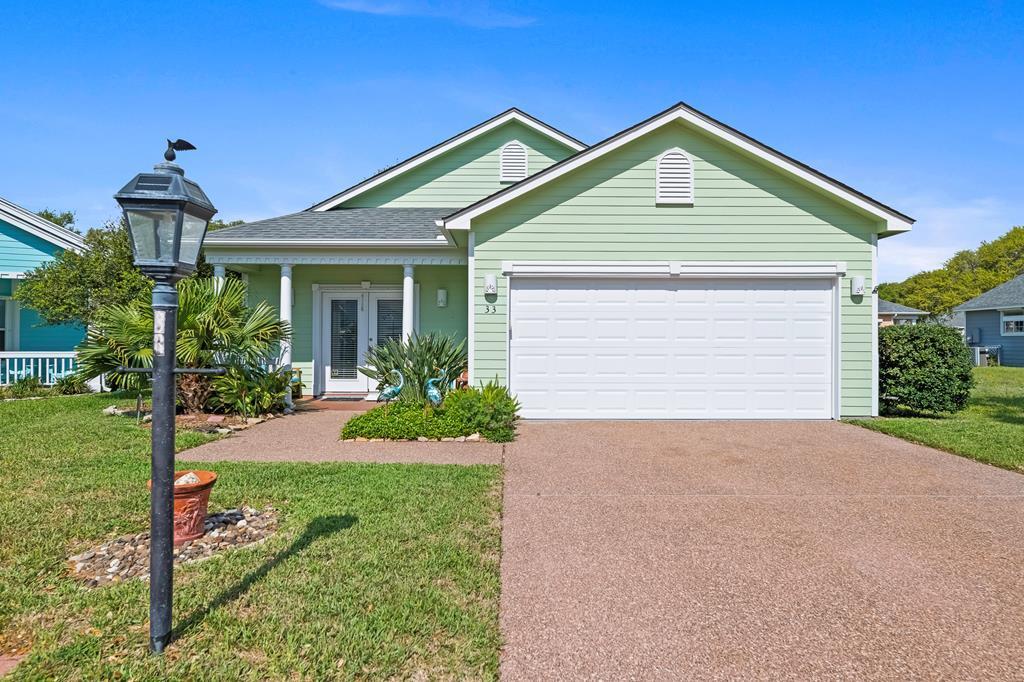 Charming and updated 3 bedroom, 2 bath home in the desirable gated community of Heron's Roost! This adorable coastal retreat features stylish upgrades, including durable vinyl plank flooring, sleek stainless steel appliances, and elegant quartz countertops. The kitchen shines with a beachy blue backsplash, while plantation shutters add charm to the living room.  Both bathrooms offer modern tile showers, glass doors, and lighted mirrors for a spa-like feel. Enjoy the convenience of a two-car garage and a fully fenced yard, perfect for outdoor living. Just a short walk to the bay and community pier—ideal for fishing, kayaking, or simply soaking in the coastal breeze!