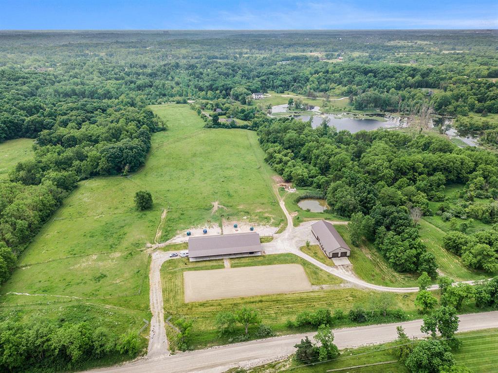 The opportunities are extensive for this incredible 25.9-acre property that features frontage on a small, private lake, an exceptional equestrian facility, and one of the most gorgeous building sites you will see anywhere in the Ann Arbor area. The beautiful setting includes 7.5 acres of woods with mature trees, rolling land, and 365 ft of shoreline on the natural spring-fed lake with a dock for swimming, kayaking, fishing, and more. The property is two parcels, sold together, with the possibility of two homes. The property includes a modern, high-end equestrian barn with 10 horse stalls, multiple fenced horse pastures, and a 1424 square foot one-bedroom, two-bath apartment. A second modern pole barn is split between a heated garage/workshop and hay storage. The property works perfectlyas a dedicated horse facility for your own horses, or as a boarding and training facility. The horse barn was constructed with maximum airflow, minimum fire risk and easy management of the horses' daily needs in mind. The barn includes a heated tack room, great storage, and high ceilings with an abundance of natural light. The apartment was designed for easy overnight stays with your horses and includes a living room, kitchen, and full bath on the main floor and bedroom and 2nd full bath on the upper level. The second barn features a fully heated work-shop area with a concrete floor and large over-head doors. The workshop is perfect for a car-enthusiast or wood-working shop. The remainder of this barn is designed for indoor hay storage, tractors, and other farm equipment. Wildlife abounds on this truly remarkable property, including bald eagles, deer, osprey and other rarer birds, and the 11-acre lake is populated with some magnificent fish.

More about the Equestrian Facility:

The stable, hay barn, and primary turnout for the horses are at the highest point on the property with 30-50ft of elevation, a large gutter/drain system, and mud-free footing that provides one of the driest equestrian facilities in Michigan. Nelson Automati