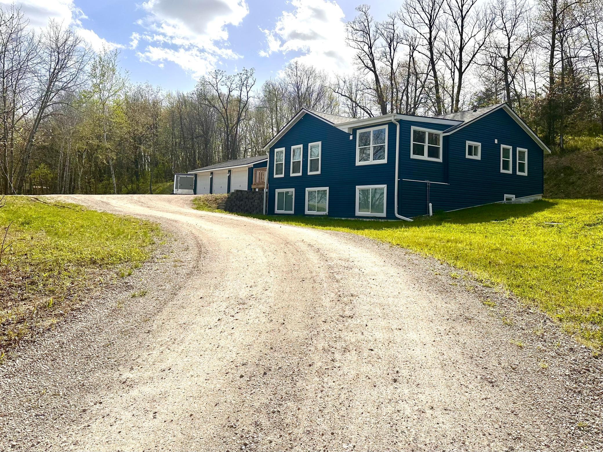 5 Bedroom, 2 Bath, 2,592 square foot home on 2.5 acres with a lake view! Gorgeous kitchen with hickory cabinets, stainless steel appliances, tiled floor and backsplash and 2 WALK-IN PANTRIES! Sunroom/dining room right off the kitchen with amazing views. Deck right off the living room. Basement has extra high ceilings and large lookout windows providing lots of natural light. Large downstairs bathroom is beautifully tiled with a double vanity. 2 large downstairs bedrooms are equipped with 2 closets each and a great views of the lake as well. Large laundry room with loads of storage space and tiled floor. 3 stall garage with heated and insulated workshop. The public access for Cedar Lake is just a few yards away and the golf course is only 4 miles south.