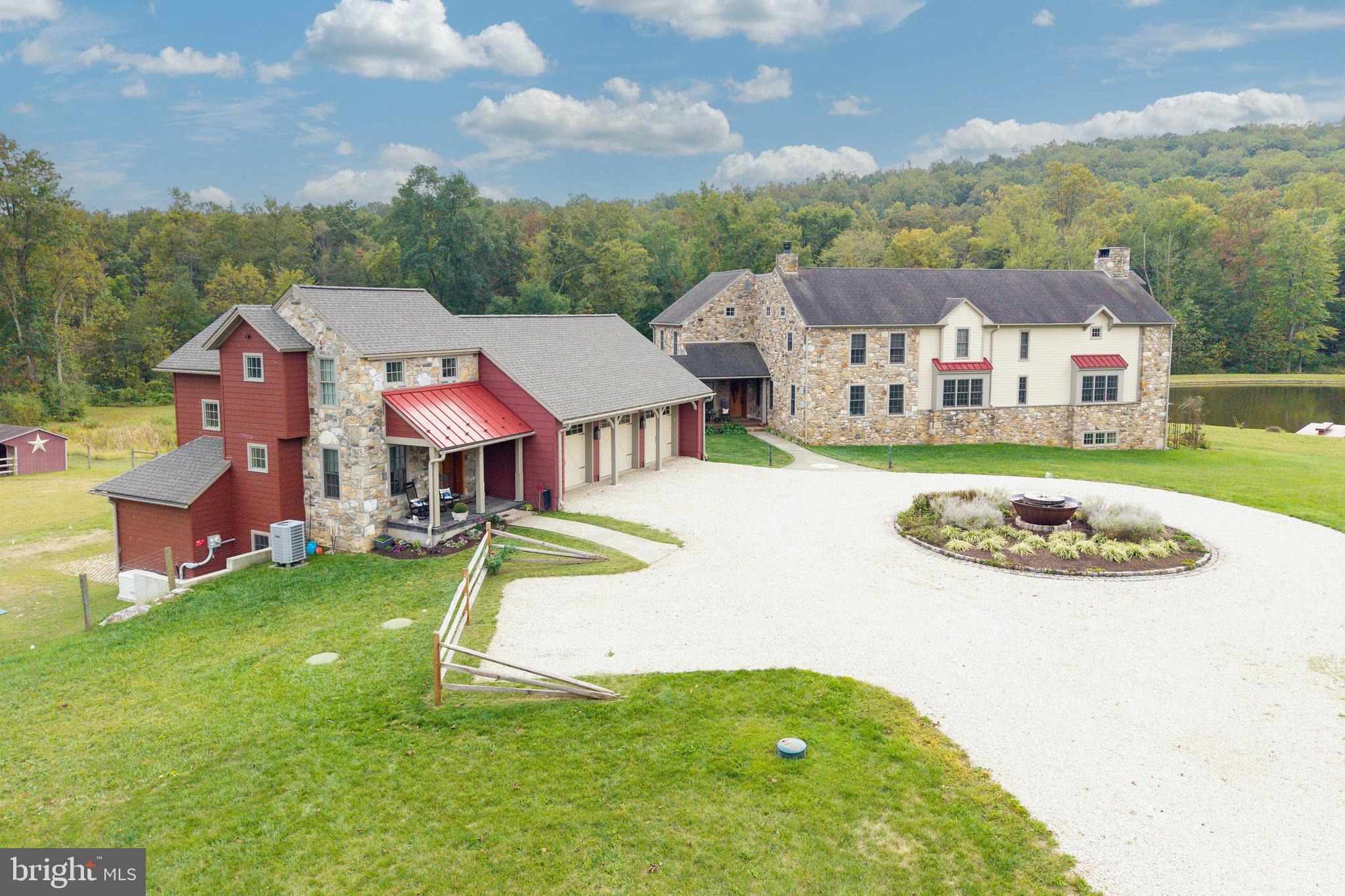 PRICE IMPROVEMENT!! Welcome to Grist Mill Farm- The dream that turned into a reality!! This 7,000 sq ft Masterpiece was built in 2007 and sits on 35 acres of which 25 acres is wooded.  The home was built with historic elegance, modern comfort, luxury and function. Starting out w/ a circular driveway, that features a Cast Iron Sugar Kettle fountain w/ water and elec. with the millstone being from the original grist mill. The cobblestones surrounding the fountain area are from Fairmount Ave in Philadelphia. The covered front porch has a bead board ceiling and covered walkway to the 3 car garage. The home is made of Hardieboard and Pennsylvania fieldstone from the previous grist mill est. 1820’s.  Enter thru the Mahogany front door you find the foyer which has 16x16 cobbled Travertine tile, a mudroom w/ dog shower,  cabinets and an O/E.  There is also a powder room w/ 16x16 cobbled Travertine tile, Kohler toilet and Sink.  The elegant Study w/ 18 lite French Dbl Doors, Kahrs engineered hardwood flr, crown molding, chair rail, built-in book shelves, mahogany window sills, cigar fan and a cozy propane fireplace w/ granite hearth. The main rooms have 5” Kahrs engineered hdwd floors.  You can relax in the Hearth room w/ a Propane fireplace w/ granite surround.  The well appointed Chef’s Kitchen is adjacent and has a 50”x 108” Granite island, numerous cabinets in custom mahogany island, 4 corner electric, Warming tray and a 18” sink.  The Upgraded Viking line appl. are Microwave, Elec Wall oven, 48” stove has 6 burners w/ griddle and 2 Ovens (1 French).  There is also a Bosch D/W, a porcelain farm sink, 4"  back splash with all pull out drawers that retreat, Impressive 42” Custom Cabinets and a 48” 2 piece Thermador Fridge and Freezer. The DR has Lighted glass cabinets and a wine fridge. The Butler’s pantry has 2 sides of cabinets and a leather granite top. The 2 story Family Room, complete with stone walls, and all stone Rumford fireplace from Floor to Ceiling with a handmade brick surround, known for being highly efficient with a tall and shallow firebox which allows heat to reflect into the room. You have 2 entrances to the 602 sq ft NEW Premium Trex deck w/ 2 ceiling fans.  In the back of the property you will marvel at the 1.75 acre pond w/ 4 aerators and is stocked w/ fish. On the 2nd floor, The Majestic Mstr. Suite has French doors to a 8’ Deck, Granite surround Gas fireplace, H/H closets from Closets by Design and a Juliet Balcony overlooking the FR. The Sumptuous MBA has a Bain Ultra jacuzzi w/ small jets and a heated back rest, His/Her porcelain sinks w/ granite tops, tiled shower w/ frameless glass door, 4 Body jets, 20x20 tile floor and a separate water closet. The 2nd flr has a Laundry room with 2 Addt’l Br’s which feature hdwd floors, access to the attic and a full hall bath w/ 12x12 ceramic tile and Full tiled Shower. The Garden Level leads you to a 4th BR w/ 2 closets, 3rd Full Bath w/ travertine sink top and a large outside patio to enjoy your oasis.  There is a Hobby Rm, Large Rec area, Bar area w/ Lighted glass Cherry cab., wine fridge and copper sink. There is a Lg workshop w/ multiple windows, Heat and A/C and Dbl doors to the Outside. Featured upgrades: All rounded corners, master switch for 1st flr lights On/Off, All switches have dimmers, All windows are 24” deep. Each window has a night light with auto on/off at dusk/dawn. There is a security system and a built-in house stereo. Upgrades also include All lighting, Faucets, Cabinets and Auto. Generators for house and Office, 2025 Well McClain Boiler w/ 11 heating zones, 3 Zone A/C and radiant heating on all 3 floors. The ext. features inc. a 3 car Gar. w/ 3 openers, equip. Shed, run in w/ elec. and water and 6 raised garden beds, The NEW 2 story Office next to Barn is 900 Sq ft, w/ LR, BR, 1 1/2 bath, Kitchen and a Deck overlooking pastures. Located in the Award Winning Downingtown school dist. w/ the STEM Academy!!  Show and Sell!!!
