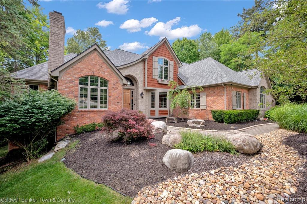 Nestled on nearly an acre lot, backing to 15 acres of wooded commons, this home sits on a cul-de-sac in the Lakes of Indianwood. The charm begins outside with a custom brick & stone elevation, European-style shutters, composite decking, and a brick walkway leading to a welcoming porch.
Inside, the open floor plan features 20-ft ceilings in the entry and great room, 10-ft ceilings throughout, and peaceful views from every window. The main level includes a spacious primary suite and a well-appointed kitchen with Wolf appliances, cherry cabinetry, and a sunny breakfast nook opening to a large composite deck. The first-floor laundry includes an extra pantry for added convenience.
Work from home in the bright library/office with a natural wood-burning fireplace. Unwind with a bottle from your wine cellar and relax by one of three fireplaces. Upstairs are three bedrooms—two share a Jack & Jill bath with jacuzzi tub, and one has a private en-suite bath.
The walkout lower level offers a full bath, wine cellar, cedar sauna, dual-sided gas fireplace, and new American cherry hardwood floors. Step outside to a brick patio or soak in the hot tub on the lower deck, surrounded by mature trees.
Enjoy access to Duck Lake (non-motorized) and the Polly Ann Trail, all within the neighborhood. Original owners designed every detail, including central vacuum, air, ceiling fans, and professional closet systems.
Recent updates (2024–2025): new roof with 15-year transferrable warranty, furnace motor, water heater, select hickory on main floor and cherry hardwood floors in lower level, custom carpet in primary suite, new washer, dryer, and dishwasher, and new hot tub. High-speed internet, cable, and security system ready with Guardian Alarm or Arlo Security.
An exceptional opportunity you wont want to miss!