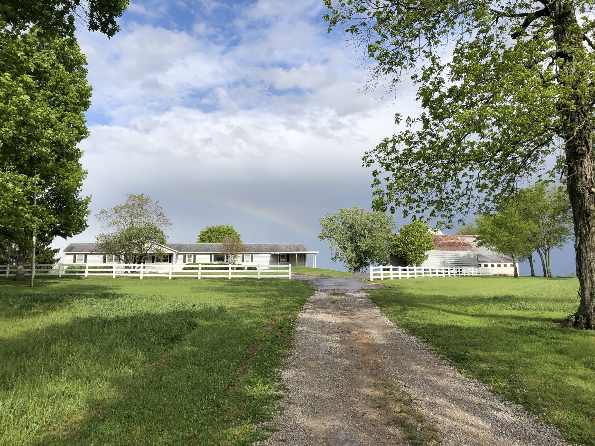 Welcome home to this spacious 4-bedroom, 3-bath ranch home offering 2,736 square feet of comfortable living space. Designed with both function and charm, the home features a large kitchen, multiple living areas, a formal dining room, a dedicated home office, and a huge laundry and mudroom—perfect for busy lifestyles. Set on 162 picturesque acres, the property is a rare opportunity to own expansive land with endless possibilities. The grounds include a large rustic barn, peaceful ponds, beautiful trees, and a mix of level and gently rolling pastures, making it ideal for farming, recreation, or simply enjoying wide-open space. From stunning sunrises to serene sunsets, this property offers lovely views in every direction. Whether you’re seeking a private retreat, a working farm, or a place to create your dream estate, this setting delivers unmatched beauty and potential. Access to I65 and Saturn Parkway is nearby making this a very convenient location. Spring Hill's shopping and dining opportunities are a short drive away and offer the perfect combination of true country living with modern convenience a short drive away.