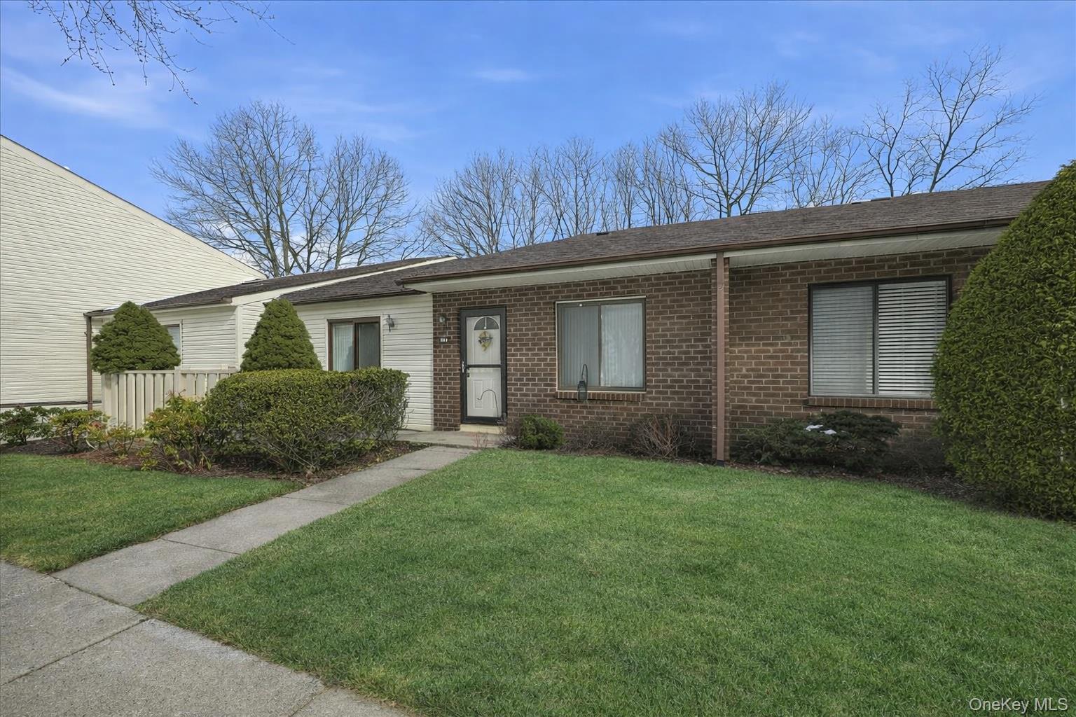 Tucked within the gated Bretton Woods community, this meticulously maintained ranch style condo offers a peaceful, resort-style lifestyle in a beautifully landscaped setting. Don’t miss out on the opportunity to own this bright and spacious 2 bedroom, 2 Full bath unit featuring 1,132 square feet of comfortable living all on ground level.  The sun-filled living room features sliders to a private patio overlooking beautiful natural surroundings, creating a serene and exceptionally private outdoor setting. The spotless kitchen flows seamlessly into the dining area - perfect for entertaining or everyday living. Both Bedrooms are generous in size, exceptional closet space throughout and both bathrooms are immaculate. The primary suite offers an ensuite bath and tremendous closet space. Inside the unit is also a Laundry/Utility Room.  Updates have been made to the forced hot air system, hot water heater, washer/dryer and windows. Another plus+ is that this unit is conveniently located close to parking for easy access. The Bretton Woods complex has amazing amenities including indoor and outdoor pools, a 9-hole golf course, pickleball and tennis courts, bocce court, fitness center, billiard, bowling, lounge, on-site restaurant and more.  Impeccably cared for and move-in ready - this is your opportunity to enjoy privacy, convenience, and resort-style living all in one.