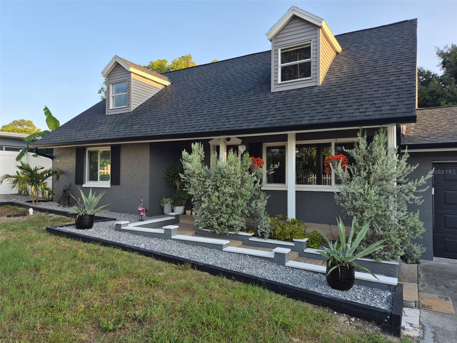 Tucked away on a quiet dead-end road, this charming Cape Cod-style property pairs thoughtful updates with a private setting.The main level features LVP flooring and an updated kitchen with full-faced cabinetry, hardened marble countertops, and Samsung stainless steel appliances from 2023. Upstairs, the private primary suite includes a spacious dressing room/closet with an organizer system and an updated bath with tile flooring, dual vanity, and marble countertop. One secondary bedroom also features floor-to-ceiling built-in bookshelves.Major improvements include a 2021 roof, dual HVAC systems with separate upstairs and downstairs controls, hurricane-impact windows, an impact-rated garage door, vinyl siding, and seamless gutters.Outside, enjoy a fully fenced yard with an oversized side gate and (RV and boat parking allowed!), Florida-native landscaping, 2024 backyard sod, a custom 10x10 shed, and a 14x16 aluminum louvered pergola. Hurricane-conscious improvements include roof rafter ties and strapping, along with reinforced outdoor structures. The oversized two-car garage provides plenty of additional space, while the backyard includes a producing banana tree grove. Best of all, the property sustained zero flooding or hurricane damage. With Lake Tarpon views, this property is a rare combination of character, updates, and outdoor living.