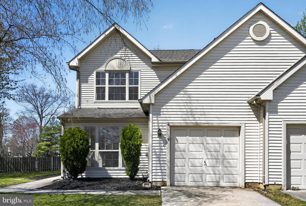 Welcome to this beautifully maintained end-unit town home, filled with natural afternoon sunlight and backing to open space for added privacy.  Step inside to a freshly painted, neutral-toned open-concept living and dining area, where abundant windows flood the space with warmth and light. The adjoining family room seamlessly connects to the kitchen and features sliding doors leading to the patio—perfect for indoor-outdoor living. The updated kitchen is sure to impress with new cabinetry, granite countertops, a stylish tile backsplash, and a convenient overhang ideal for barstool seating. The main level also offers excellent storage with two closets, along with a powder room and access to the one-car garage. Upstairs, a new statement light fixture draws attention to the open ceiling design, contributing to the home’s airy feel.  The primary suite is bright and inviting, featuring a vaulted ceiling, walk-in closet, and durable laminate plank flooring. The en-suite bathroom includes a skylight, updated fixtures and lighting, with room to make it your own. The full hall bath and laundry area are conveniently located nearby, while two additional well-sized bedrooms, both with laminate plank flooring, are situated further down the hall. Step outside to enjoy the oversized, fenced-in yard that backs to open green space, offering both privacy and room to relax or entertain. This desirable end-unit model rarely becomes available—don’t miss your opportunity to make it yours!