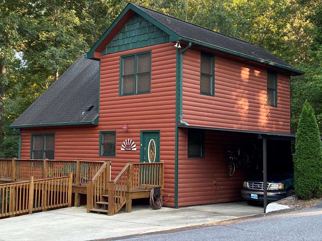 Experience lakefront living at its finest in the highly sought-after Bear Paw gated community.This amenity-rich neighborhood offers something for everyone, including a private dock. Community pool & tennis courts,basketball courts,playground,& 24/7 security  entrance for added peace of mind. Enjoy  access to the marina,complete with fishing supplies,convenience groceries,& snack bar serving ice cream—perfect for relaxing days by the water.This spacious multi-level home is designed for both comfort & entertaining and easily sleeps 10–12 guests. With 4 dedicated sleeping rooms and 2pull-out sofas, there's space to comfortably accommodate family & friends.The main level features a well-appointed kitchen with a versatile island that can be repositioned to suit your preferred seating arrangement.Step outside to an impressive outdoor kitchen & dining area equipped with a refrigerator & microwave—ideal for hosting gatherings. A second living room with a cozy pellet stove provides additional space for relaxation, while the lower level offers a private hot tub for unwinding after a day on the lake.The property includes a private boat dock, along with covered parking that can double as boat storage. The dock is already permitted through TVA, with approval to expand & add a second level if desired—offering even more potential to customize your waterfront experience.Parking is convenient & flexible, with space for up to 6 vehicles—4 in the driveway & 2 additional spots just across the street.One of the standout features of this property is the peaceful lake environment. Marina traffic is minimal, with the only noticeable increase typically around Memorial Day and 4th of July. Much of the surrounding shoreline is protected national preserve land, creating an exceptionally quiet setting with abundant calm coves & still waters—perfect for boating, fishing, & relaxing.With generous living space,thoughtful features,& a serene waterfront setting,this is an amazing property!