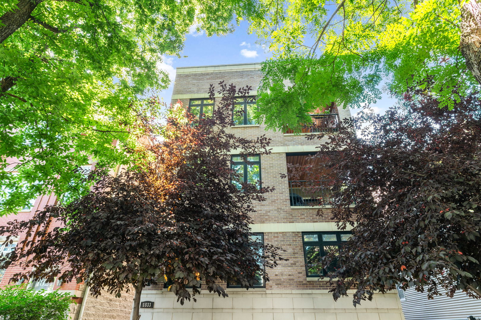 Extra-wide and filled with natural light, this stunning Roscoe Village condo checks all the boxes. Enjoy a sleek white chef's kitchen with an oversized island and premium Sub-Zero and Wolf appliances. The spacious open-concept living and dining areas feature custom millwork, wood plantation shutters, hardwood floors, modern lighting, and a beautiful fireplace.    Step outside to your oversized private balcony off the dining room or head up to your expansive private rooftop deck above the garage. Luxurious bathrooms include a spa-like ensuite with a steam shower. Garage parking included. Perfectly located steps to Roscoe Village and Lakeview restaurants and shopping! A must-see!