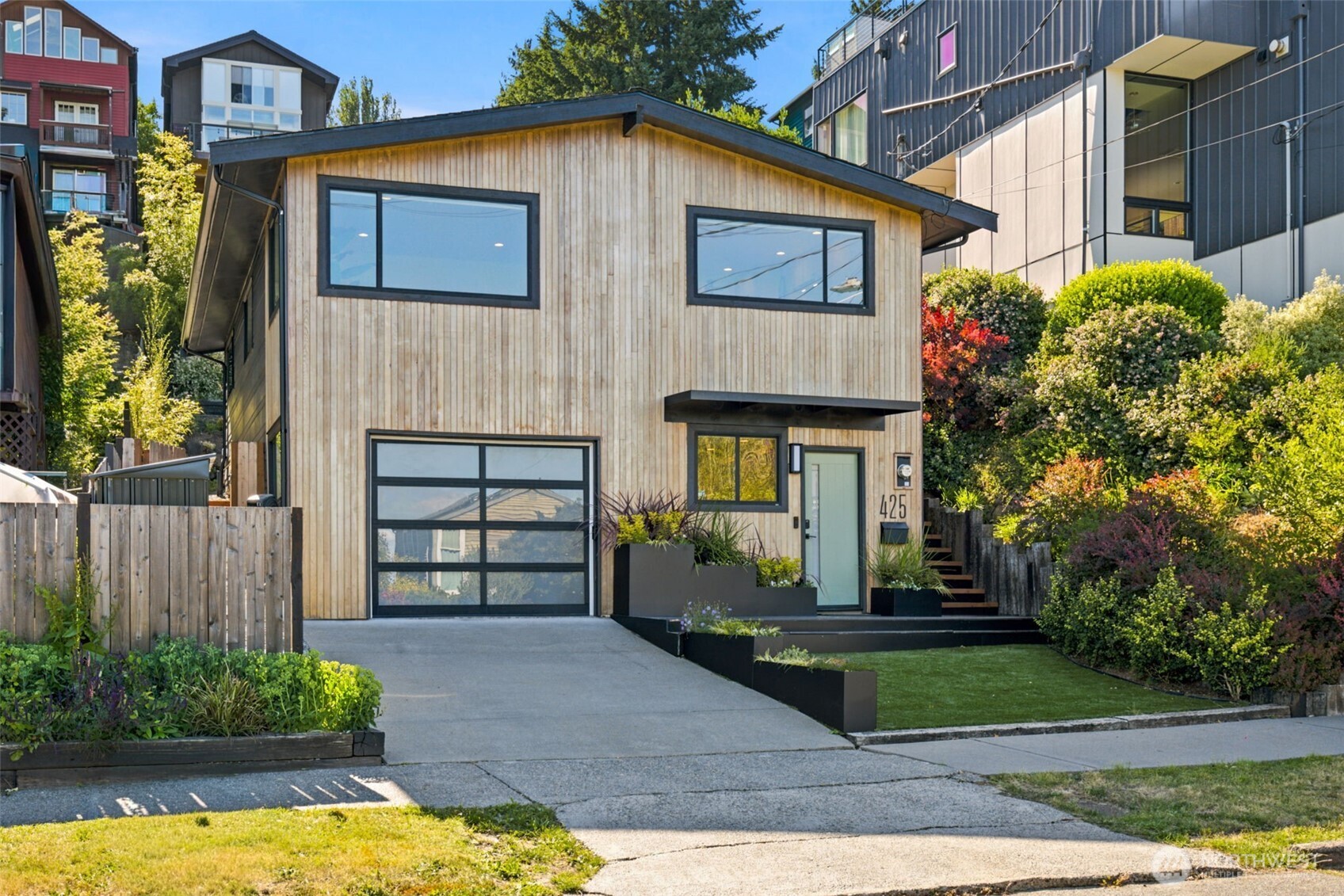 Some homes check boxes. This one changes minds. Behind its unassuming exterior is one of Madison Valley's best surprises. Thoughtfully reimagined from top to bottom, every square foot has been designed with intention, proving that great architecture isn't about size, it's about how a home makes you live. Clean lines, polished concrete floors, cabinet-grade plywood, solid core doors, integrated built-ins, and sustainable upgrades create spaces that feel warm, modern, and effortlessly functional. Mountain views set the backdrop from the kitchen, while the entertaining deck and terraced yard become natural extensions of everyday life. Morning coffee, spontaneous dinner parties, yard games, sunset hangs. This home makes all of it easy. Life changes? So can this floor plan. Creative studio, home office, gym, guest suite, multigenerational living, future ADU, or income-producing rental. It adapts without missing a beat. EV charging and extensive updates over the past five years mean your weekends stay yours. Just blocks from Madison Valley favorites, the Arboretum Loop, neighborhood cafés, and the soon-to-open PCC, this isn't just another boxy townhome pretending to be a lifestyle. It's the real thing. Designed to evolve. Built to last. Ready for its next chapter.