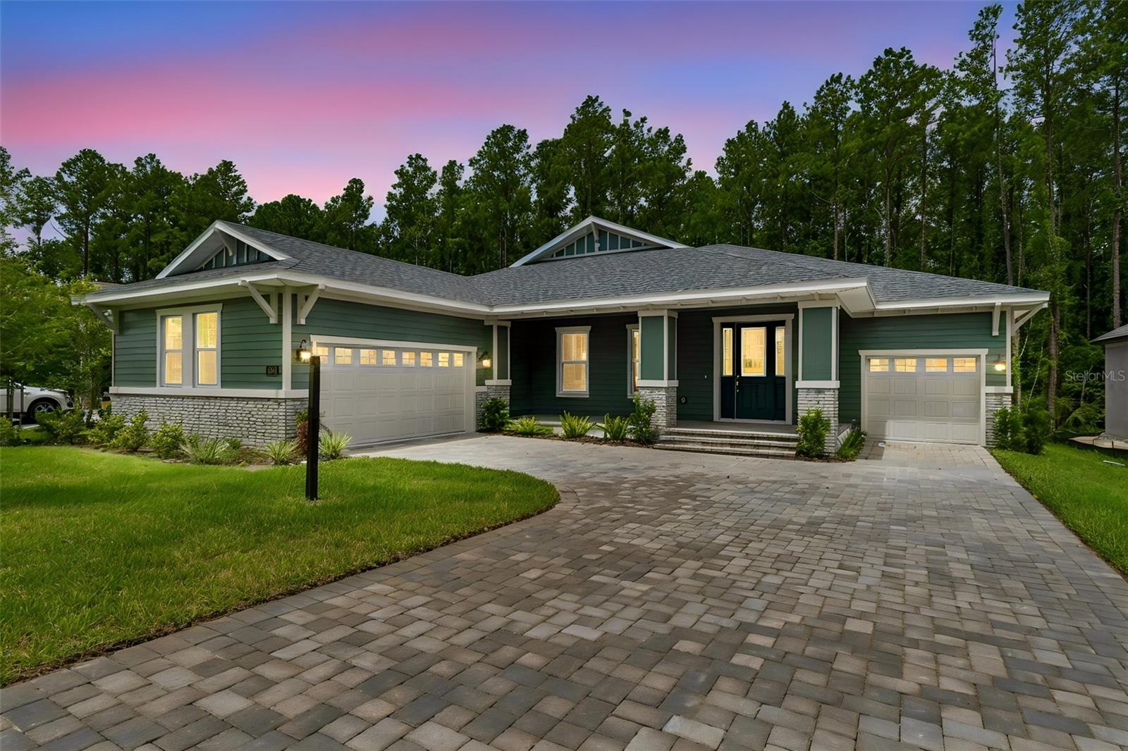 Virtually Staged. Discover exceptional living in this spacious 3-bedroom, 3-bath Rochester floor plan, offering 3,001 square feet of thoughtfully designed space in one of Tampa Bay's most prestigious gated golf communities. From the covered front porch to the expansive rear lanai spanning nearly the width of the home, this residence was built for gathering — and for everyday life.Step inside to an open-concept living area where the great room, kitchen, and dining space flow together beneath a wall of sliding glass doors and windows that fill the home with natural light. The gourmet kitchen impresses with Timberlake Portfolio 5-piece white Shaker cabinetry, quartz countertops, a subway tile backsplash, stainless steel Frigidaire appliances including a 36" gas range, a large island with seating, and a walk-in pantry. A flexible bonus space off the kitchen is ready to become a formal dining room or whatever suits your lifestyle.Two secondary bedrooms share a convenient Jack & Jill bath on one side of the home, while a private, spa-inspired owner's suite anchors the opposite wing — featuring a tray ceiling, dual walk-in closets, dual vanities, a soaking tub bathed in natural light, and an oversized frameless glass shower. Durable, low-maintenance LVP flooring runs throughout the main living areas, complemented by designer lighting, 8-foot interior doors, and premium finishes at every turn. A two-car garage plus a single-car garage provide ample room for vehicles, storage, or hobbies.Beyond the front door, residents enjoy life in Southern Hills Plantation, a gated, master-planned community set amid the rare rolling topography of Brooksville, Florida, with elevation changes of more than 200 feet and long-range views stretching nearly 20 miles toward the Gulf Coast. At the heart of the community is the private, 18-hole Pete Dye championship golf course — rated among the Top 100 residential courses in the United States by Golfweek — along with a 6-hole par-3 course, driving range, and full practice facilities. The 20,000-square-foot clubhouse, styled after a classic old Florida estate, anchors a resort-style lifestyle that includes a full-service spa and fitness center, four tennis courts, a resort-style pool, and miles of scenic walking trails. In 2026, the club joined Heritage Golf Group, bringing continued investment in amenities and member programming.Minutes from I-75 and the Suncoast Parkway, and just a short drive to historic downtown Brooksville, this home offers the perfect balance of privacy, luxury, and connectivity — with Tampa's dining, culture, and airport all within easy reach.