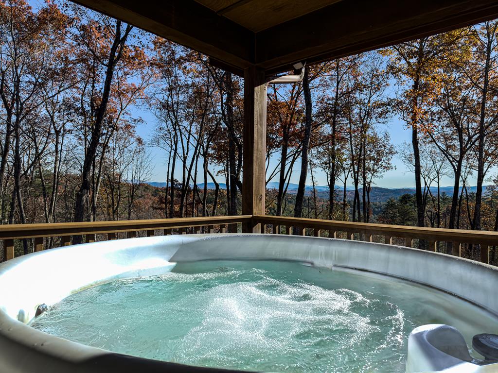 Welcome to your very own 16.03 acres of pure mountain peace — a beautiful stretch of wooded land wrapped in breathtaking long-range views and absolute privacy. With the USFS boundary stretching along the back, you've got guaranteed seclusion and unlimited hiking right out your door. Or, if you'd rather take it slow, settle onto the full-length covered front porch, slip into the hot tub, and let those big mountain skies wash the day away. The home itself is solid and inviting, with an open kitchen, living, and dining area anchored by a handsome stone wood-burning fireplace — the kind that makes chilly evenings feel extra cozy. On the main floor, you'll find two generous bedrooms and two full baths, perfect for comfortable everyday living.  Downstairs, the full basement offers even more room to spread out, featuring a bonus room, a spacious family room, and another full bath — ideal for guests, hobbies, or your own private retreat. A circle drive makes coming and going a breeze, and the private well adds to the self-sufficient feel of the property.  A rare combination of privacy, views, and quality living — tucked away, yet close enough to everything you need. Come breathe it in.