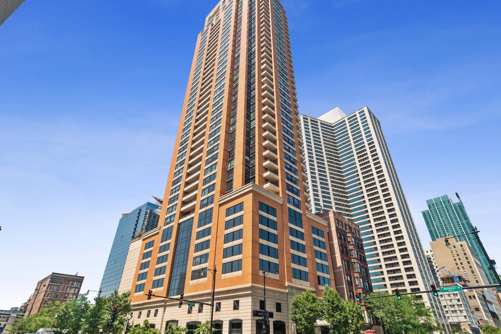 You will be captivated by the sweeping views of the Lakefront, Museums, Grant Park, Navy Pier and the skyline from every turn in this home. Spend the days gazing at the boats passing by while chilling on your East facing balcony or from your living room perched high in the sky with SE corner windows! This incredible unit and floorplan leaves nothing to be desired with a proper foyer entry to greet you, a bonus powder room for maximum convenience and privacy, 2 primary suites (what?!), a thoughtfully opened up & remodeled kitchen, a separate dining room and tons of storage throughout. The sleek & modern kitchen showcases flat panel cabinetry, quartz tops & breakfast bar for additional seating. The separate dining room is ideal for entertaining and gathering with custom built ins that offer extra serving space & storage including wine cooler. Wake up to the beautiful sunrises over the Lake from your spacious main bedroom suite and then make your way into the updated marble bathroom with Euro height double vanity & honed counters, separate shower, Jacuzzi tub and additional built in storage. The enormous, organized walk in closet will make you the envy of all of your friends! Chef's kiss! The newly refinished hardwood floors throughout are simply stunning. This home drenched in sunlight, high in the sky, truly offers amazing views in every direction including a surprise view of the river, bridges and other vistas that will provide interest and enjoyment each and every day. Building offers 24 hr door staff, dog run, business center, a penthouse exercise room with views plus a fabulous club room with attached sundeck. Unbeatable South Loop location in the heart of it all! Heated garage parking 30K
