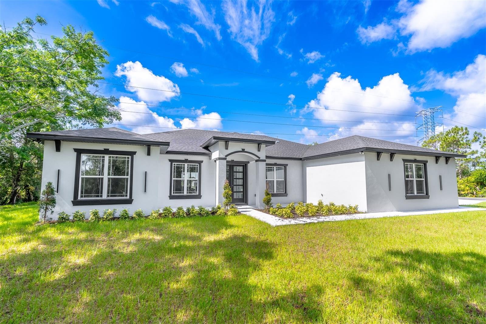 **MOVE-IN READY HOME. *Stunning newly built luxury home located in the highly sought-after Wedgefield Equestrian Community, offering new construction, energy-efficient design, and upscale finishes throughout. This elegant Chelsea model features approximately 2,700 square feet of thoughtfully designed open-concept living space with high vaulted ceilings that create a bright, airy atmosphere ideal for modern living and entertaining.The spacious primary suite provides a private retreat with large walk-in closets, while the secondary bedrooms are generously sized with high ceilings, perfect for family, guests, or a home office. The gourmet kitchen is a chef’s dream, showcasing stainless steel appliances, including a cooktop, built-in oven, vented hood, and dishwasher, paired with Quartz countertops and 42-inch all-wood cabinets with soft-close drawers.Additional highlights include recessed LED lighting, ceiling fans throughout, energy-efficient features, an oversized 3-car garage, and striking double front entry doors with glass inserts. The open living areas flow seamlessly to the outdoor entertaining space, ideal for hosting or relaxing.Located in a golf course community, residents enjoy access to a championship 18-hole golf course, country club, bicycle lanes, community park, playground, picnic pavilion, and extensive sports facilities including baseball, softball, soccer, football fields, and a sand volleyball court. Outdoor enthusiasts will appreciate nearby equestrian trails, horse-friendly areas, fishing lakes, and nature preserves at the Hal Scott Preserve.Conveniently situated near Orlando International Airport, UCF, Downtown Orlando, Disney, Port Canaveral, major highways, dining, shopping, and entertainment—this exceptional property offers the perfect blend of luxury living, new construction, golf community lifestyle, and Central Florida convenience