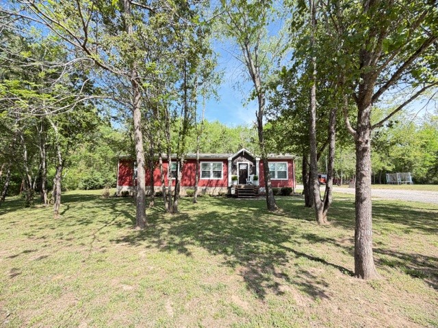 Welcome home to this gorgeous 3 bedroom, 2 bath retreat perfectly situated on approx. 1.24 acres of pure serenity. If you've been searching for room to spread out both inside and out-this one delivers. Step inside and enjoy not just one, but two spacious living areas. A comfortable main living room plus a cozy den, perfect for movie nights, a home office, or a separate hangout space for guests or family. Flexibility like this is hard to find! Outside, the charm continues with a relaxing firepit area-ideal for quiet evenings under the stars or entertaining family. And don't miss the impressive 12x48 storage building equipped with electricity giving you all the extra space you need for tools, toys, or hobbies. 30 amp RV hookup next to storage building. Tucked away with the privacy you've been dreaming of, yet still convenient to everything-this property truly offers the best of both worlds.