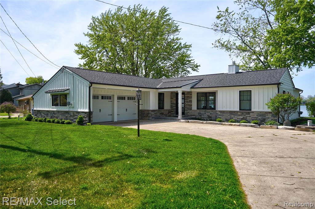 This amazing home on Lake Fenton was completely rebuilt in 2020 inside and out, this stunning home offers jaw-dropping sunset views and top-tier craftsmanship throughout. Professionally designed with a wide-open floor plan, the gourmet kitchen boasts custom cabinetry, a large island, quartz countertops, and stainless steel appliances—all flowing seamlessly into a firelit living room. A dramatic wall of Pella windows and doors frames the lake and opens to a brick paver patio, perfect for summer entertaining.

The spacious, newly landscaped lot features elegant limestone beds and a sturdy sea wall. Inside, you’ll find hardwood floors, a custom living room ceiling, and spa-like ceramic baths. The primary suite offers a large walk-in closet, while every detail reflects exceptional custom quality. This move-in-ready beauty is your ticket to Lake Fenton summer fun!