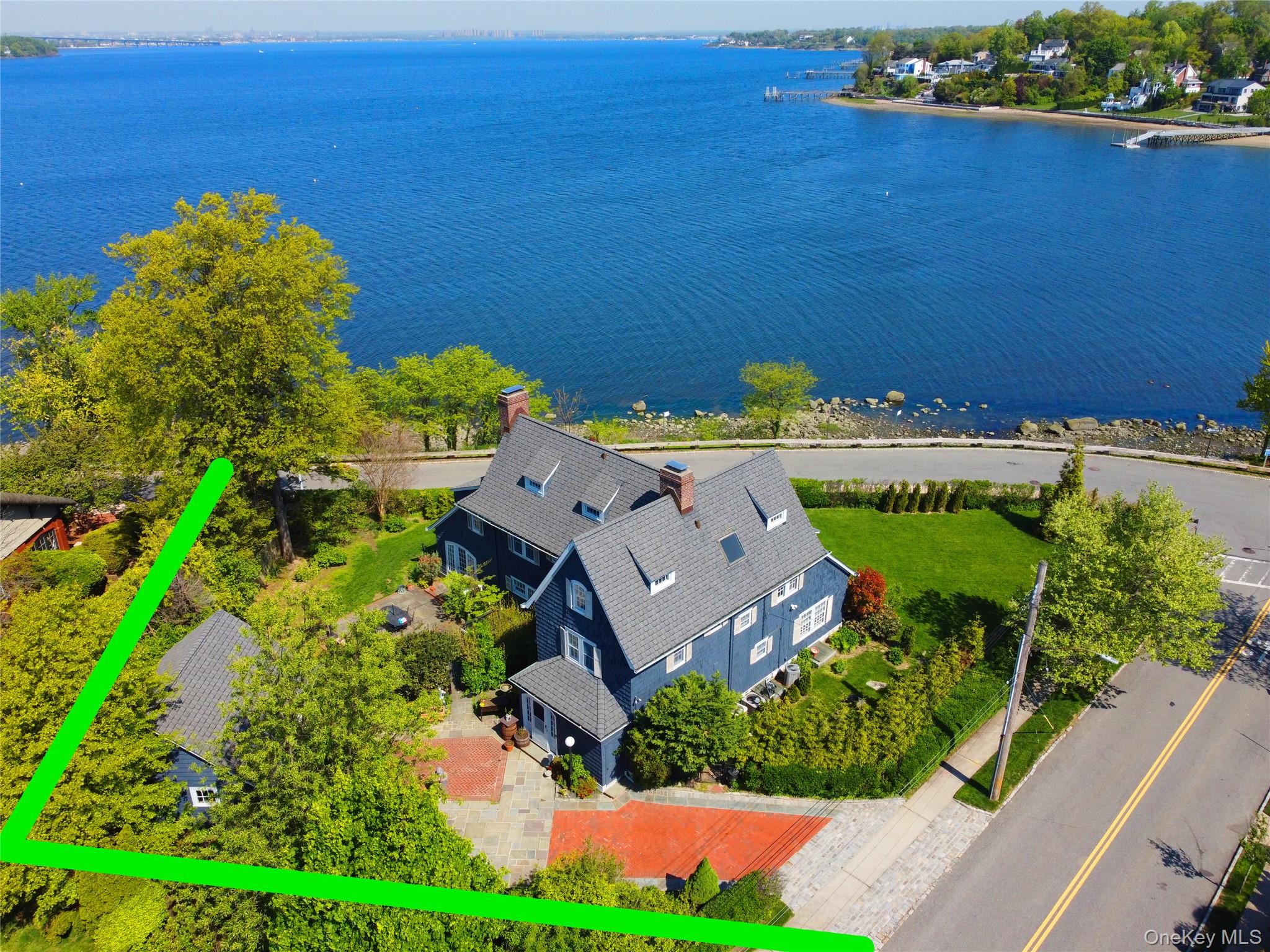 Experience the pinnacle of Gold Coast living at The Point at Douglaston Manor, a premier 6-bedroom, 4-bathroom waterfront estate. This architectural masterpiece seamlessly blends classic heritage with modern updates, featuring panoramic water and sunset views from nearly every room. The interior boasts 9-foot ceilings, exquisite millwork, three elegant fireplaces, and a renovated chef’s kitchen with a true butler’s pantry. Highlights include a sun-drenched garden parlor with floor-to-ceiling windows and a primary retreat with a flexible office/gym suite. The home currently offers nearly 4,000 sqft of refined livable space within a 5,383 total sqft footprint. Beyond the existing structure, the property offers incredible growth potential with 5,984 sqft of additional buildable area (Check with Architect). Recently approved permit for a 16' x 36' swimming pool—a rare and valuable head start for your backyard oasis. Nestled in a secure community with a dedicated neighborhood security patrol, residents also enjoy exclusive access to a private community dock for boating, fishing, and swimming. Perfectly located blocks from the exclusive Douglaston Club; 1 mile from LIRR, easy commute to Penn Station, this rare gem combines the tranquility of waterfront living with the benefits of low city taxes and top-tier NYC District 26 schools. Selling "As is" .All information is deemed reliable but not guaranteed.