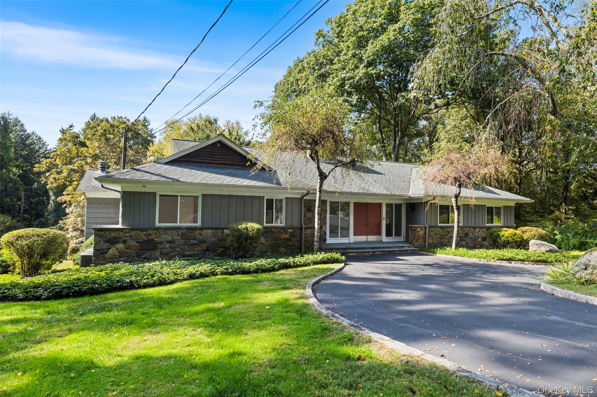 Rarely does a home come on this sought after street.  Set at the end of a quiet cul-de-sac on 2.27 acres, with an adjacent 2 acre lot also available, the property offers privacy and endless possibilities.  Build your dream home, renovate the existing home featuring a pool and poolhouse, or expand with the neighboring lot.   Easy living awaits in this spacious 5 bedroom ranch with a floor plan that is both functional and inviting.  An inviting circular driveway welcomes you to a spacious front entry with a beautiful stone wall, setting the tone for the character throughout.  Inside, the living room features a gorgeous stone fireplace, while outside a 2nd fireplace enhances the patio-perfect for year round enjoyment. Generously sized rooms flow naturally and can be easily reimagined to fit one's lifestyle.  The walk out lower level adds flexiblity-whether you need a home office, guest space or family room.  Lower level showcases a spacious family room with fireplace.  Whether you are a first time buyer, downsizer looking for one floor living or searching for a project with strong upside, this home delivers options.  Minutes to the hamlet of Armonk, within Byram Hills school district, this home is a winning combination of location and potential.  Home being sold strictly as is.