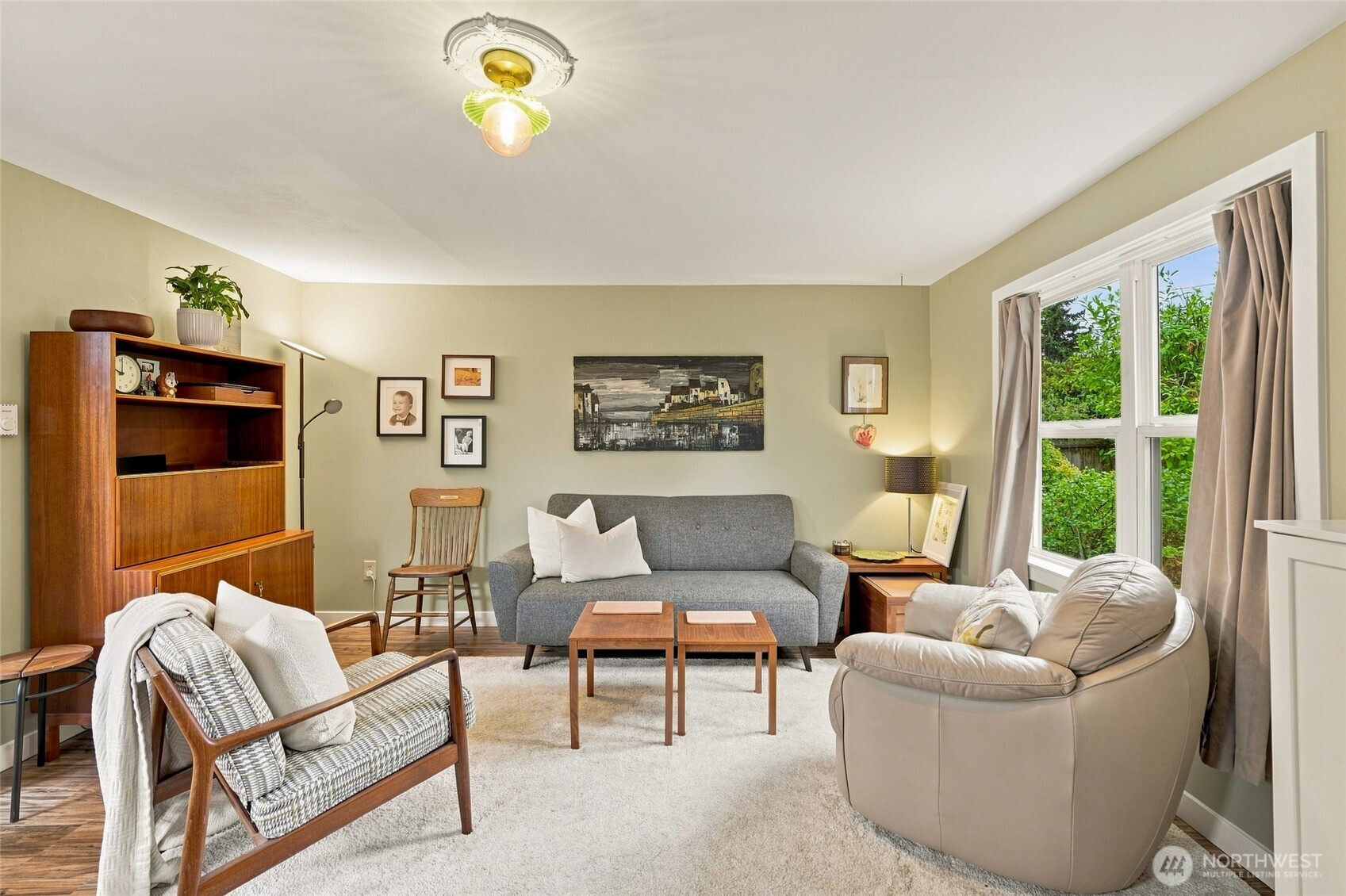 Welcome to this inviting two-bedroom, one-bath home in North Seattle. The easy one-level layout features a spacious living room, attractive flooring, and comfortable everyday living. Step outside to a fully fenced backyard with mature landscaping and plenty of room to garden, entertain, or simply relax in your own private outdoor space. A covered carport provides convenient year-round parking, while two utility buildings offer valuable additional storage. Enjoy convenient access to shopping, dining, public transit, nearby parks, the Burke-Gilman Trail, Lake Washington, I-5, and downtown Seattle. With generous outdoor space, practical storage, and a convenient North Seattle location, this home offers a wonderful opportunity to make it your own.