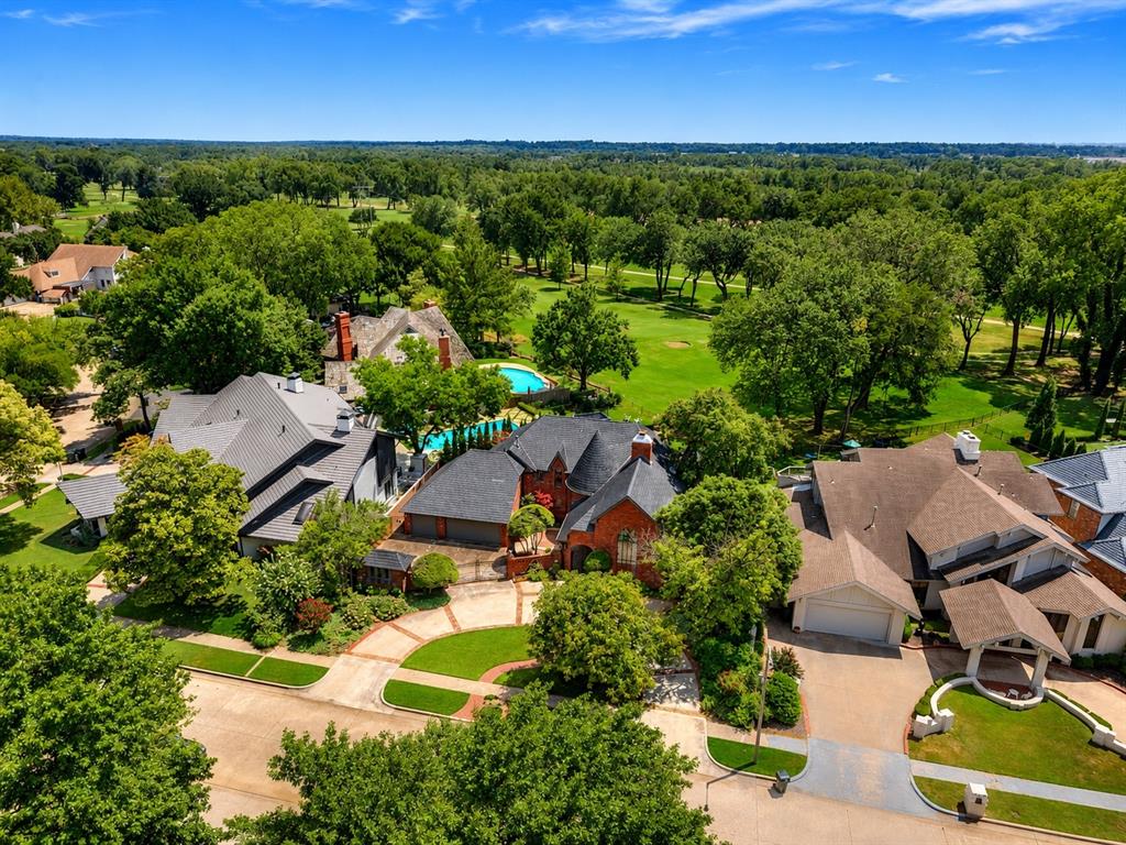 One of The Trails most architecturally significant homes...backing directly to the golf course, this  remarkable residence is a designers dream offering an incredible chance to create something truly spectacular! With very few golf course properties available in this highly sought-after community, this home presents exceptional value and unlimited potential. Designed with timeless craftsmanship, the home showcases dramatic cathedral ceilings accented by massive exposed wood beams, a stunning curved wood staircase, striking architectural elements and distinctive design details throughout. The quality of construction and unique character provide an extraordinary foundation for either a thoughtful cosmetic update or a complete luxury transformation. A simple renovation with updated paint, flooring, lighting, and fixtures would dramatically modernize the home while preserving its incredible architectural integrity. For those seeking a more extensive redesign, the layout easily lends itself to creating two spacious upstairs bedroom suites while relocating the primary suite to the main level. Designed for flexibility, the expansive great room can function as either a grand living area or an impressive dining space for entertaining. The formal dining room could easily become an executive study or library, while the additional living room offers flexibility as either a sitting/tv room or formal dining area. A bonus area provides the perfect space for a game or pool table or just a few lounge chairs to enjoy the views! This is a home where vision meets opportunity—the possibilities are exciting! Some photos have had virtual renovation design to show what it could be and how easy it would be. Other great features include a new DaVinci roof, generator, in-ground storm shelter, 3 car-garage with backyard garage door access and gated courtyard. Virtual renovation concept
