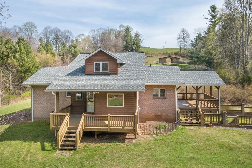 Tucked away in the peaceful countryside of Laurel Fork, VA, this remarkable 3 bedroom, 3 bath home sits on 72 acres of pure mountain beauty, offering unmatched privacy and a setting that feels straight out of a storybook. With extensive frontage on Tory Creek, a spring-fed branch, and a tranquil pond, this property is a rare blend of natural beauty and functional land.  The home is thoughtfully designed to embrace its surroundings, featuring large windows that capture breathtaking views of the rolling hills while maximizing passive solar efficiency. Inside, the kitchen showcases beautiful wormy chestnut cabinetry and oak, and the living room invites you to unwind beside a cozy woodstove. An upper-level loft, open yet set apart from the main living areas, provides flexible space that could serve as an additional bedroom, office, or private retreat.  The lower level expands your living space with a welcoming bonus area, comfortable den, third bedroom, full bath, and a storage/utility room—ideal for guests or multi-generational living.  Step outside to a charming fenced courtyard complete with a wooden deck, raised garden beds, and a curving brick wall—perfect for cultivating your own organic vegetables, herbs, and flowers. The land itself offers a desirable mix of open fields and wooded acreage, with gently rolling terrain suited for recreation, hunting, or farming. Wildlife is abundant, making this a true retreat for nature lovers.  Additional features include a barn, fencing and cross-fencing for livestock or hobby farming, and a prime homesite overlooking Tory Creek with a well already in place and electricity available—ready for a second home or guest house.  If you've been searching for a private mountain escape with character, versatility, and breathtaking scenery, this one-of-a-kind property is ready to welcome you home.
