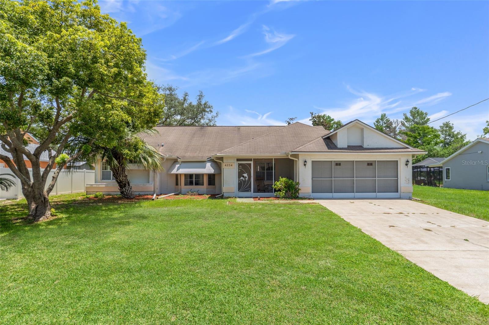 Welcome to this meticulously cared-for home located in the heart of Spring Hill, just minutes from the springs and outdoor recreation of Weeki Wachee. Owned and lovingly maintained by the same owner for over 20 years, this solid block home blends original charm with excellent upkeep. The home features a bright, functional layout with a screened-in front porch for morning coffee and an enclosed rear porch that’s perfect for relaxing or entertaining. The backyard is fully fenced, offering privacy and space for pets or outdoor enjoyment. You’ll also appreciate the convenience of a built-in irrigation system that makes yard maintenance easy. The oversized 2-car garage provides room for storage, tools, or a hobby space. Located on a quiet, well-kept street with no HOA, no CDD, and in Flood Zone X, so flood insurance isn’t required. Close to shopping, dining, parks, and the Gulf Coast, this home offers great value in a prime location. Whether you're looking for a peaceful full-time residence or a seasonal escape, this one is move-in ready with room to personalize.