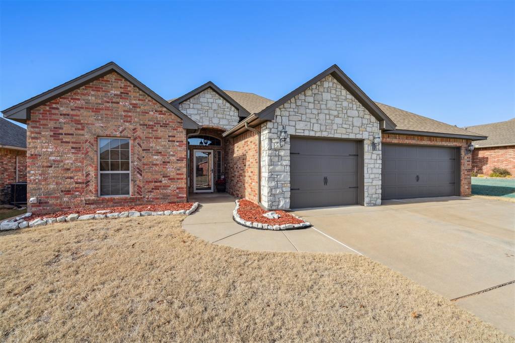 Welcome to the FABULOUS Monterey Addition! - A fantastic family-friendly neighborhood, Just MINUTES from the University of Oklahoma, great parks, walking trails, and TONS of exciting new growth and development! This beautifully maintained one-owner home delivers the perfect combination of location, style, and standout features, including an incredible 28-foot-deep EXTENDED THIRD-CAR GARAGE - ideal for big trucks, boat storage, trailers, or a dream workshop. A gorgeous front yard, covered front porch and inviting curb appeal welcomes you home to a spacious split floor plan – complete with tall ceilings, beautiful crown molding, bull-nosed edges, pretty archways, hand-scraped wood flooring, and a cozy stone fireplace. The huge open kitchen offers beautiful woodwork, granite countertops, travertine backsplash, a large island, big pantry, and tons of cabinet space. The primary bedroom suite features bright windows and a striking tray ceiling, along with an ensuite bath that includes a huge walk-in closet, double vanity, relaxing soaker tub, and a HUGE separate walk-in tile shower with river rock floor. Secondary bedrooms are generously sized with excellent closet space, and the guest bath is neatly designed & convenient. You will LOVE the well-planned utility room and mudroom space that leads directly out to that impressive extended garage. Step outside to a large covered back patio overlooking a charming yard with an outbuilding for extra storage. MOVE IN READY! With unbeatable proximity to OU, restaurants, shopping, and so much more, this is one you’ll want to see right away. Schedule your showing today!