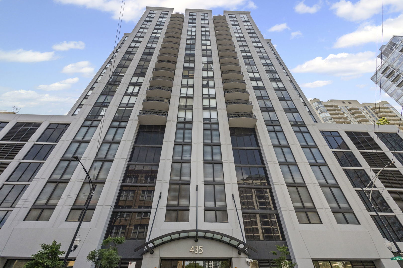 Parking Included! Breathtaking Panoramic Skyline Views from This Immaculate River North Condo! Perched on the 12th floor of the luxurious Erie Centre, this stunning 2-bedroom, 2-bath residence offers floor-to-ceiling windows in every room, flooding the home with natural light and showcasing sweeping city views. Step into a spacious open-concept layout with stylish laminate hardwood floors throughout and an expansive living/dining area that leads to your private balcony-ideal for relaxing or entertaining. The updated kitchen is equipped with granite countertops, 42" mocha cabinetry, stainless steel appliances, an island with seating, and generous storage space. The large primary suite features two sizable closets and an elegant en suite bath with a walk-in shower. The second bedroom is equally spacious, with continued skyline views and ample closet space. Additional highlights include in-unit washer/dryer, extra storage, and a well-maintained full-amenity building offering a chic lobby, 24-hour doorman, fitness center, party room, rooftop deck, and elevator access. Prime River North location-steps from CTA, Starbucks, Larrabee Dog Park, shopping, and many of Chicago's best restaurants and nightlife. Don't miss this rare opportunity to own a luxury condo with iconic views in one of the city's most vibrant neighborhoods!